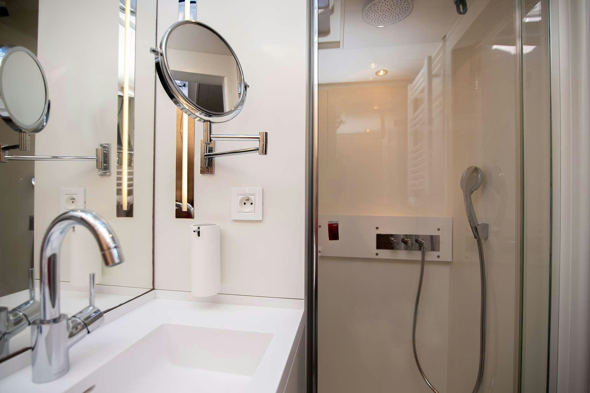 a bathroom with a sink and a mirror aboard BUBBLES Yacht for Charter