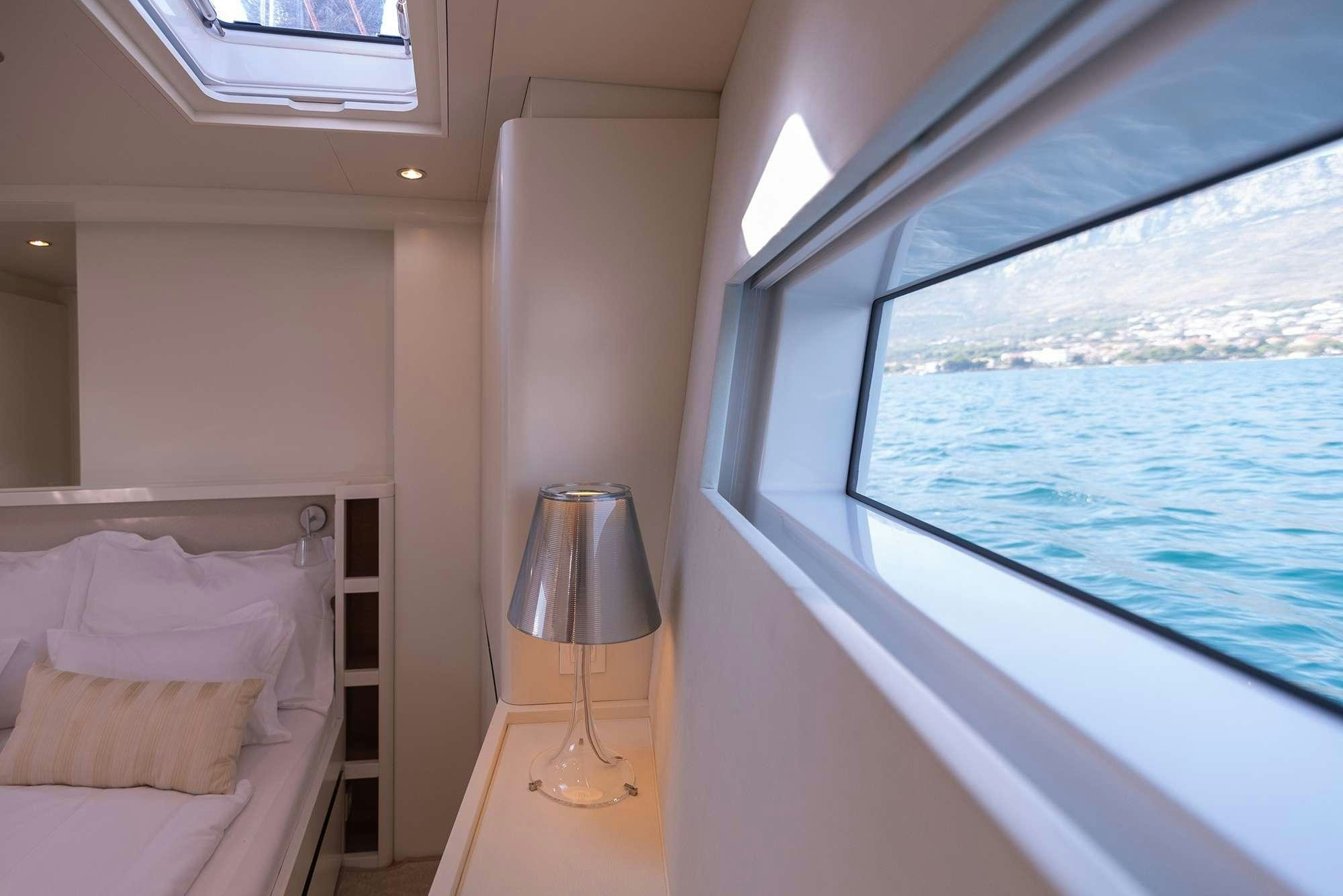 a room with a window and a bed aboard BUBBLES Yacht for Charter