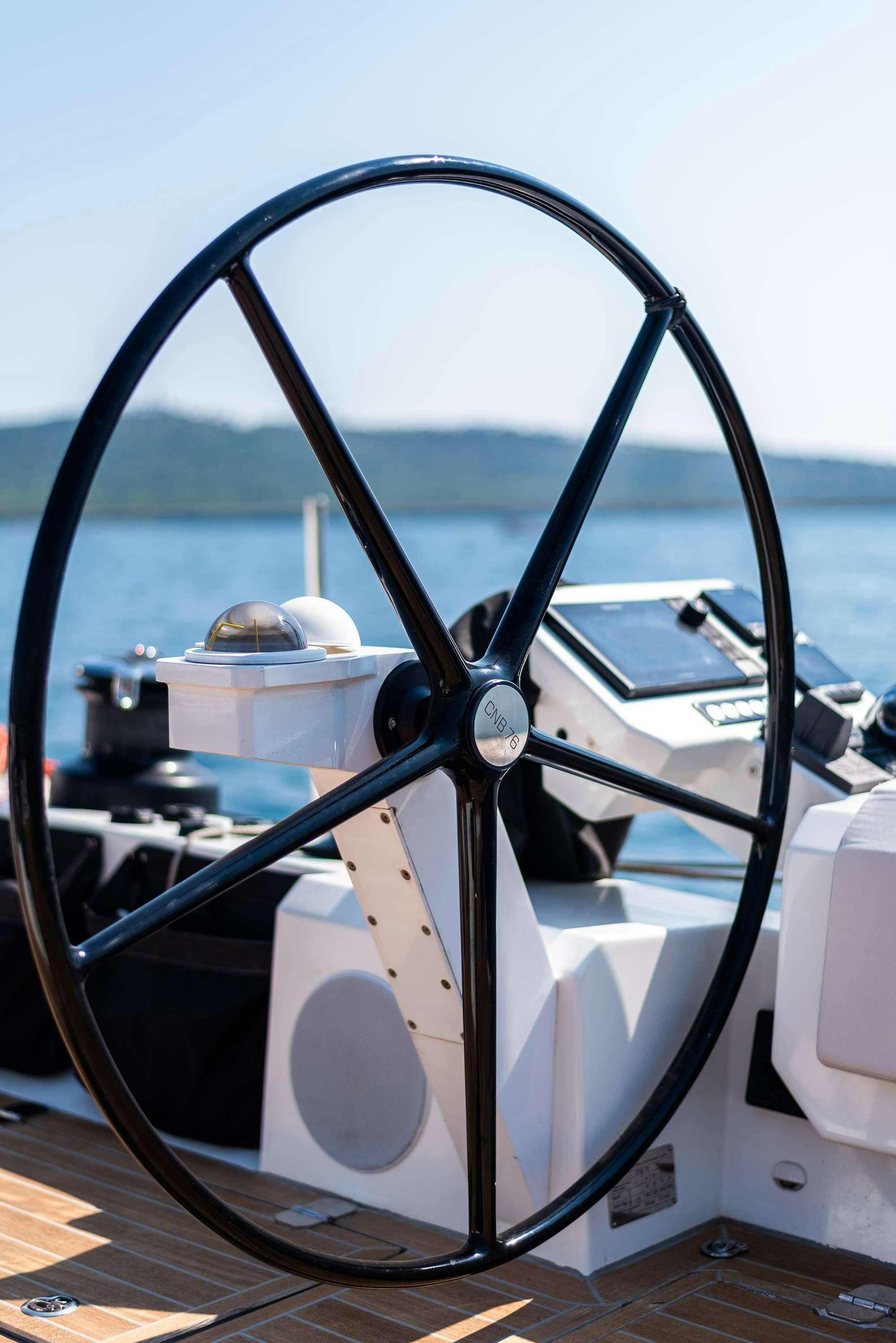 a large white car with a large mirror aboard BUBBLES Yacht for Charter