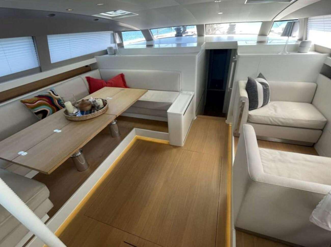 a room with a couch and a table aboard BUBBLES Yacht for Charter
