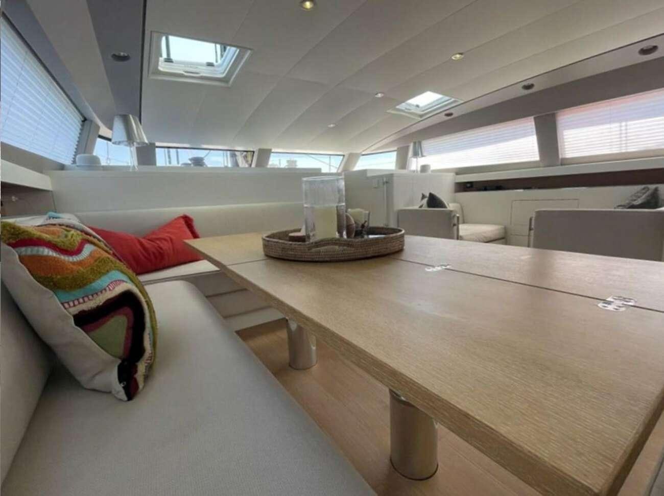 a room with a bed and a table aboard BUBBLES Yacht for Charter