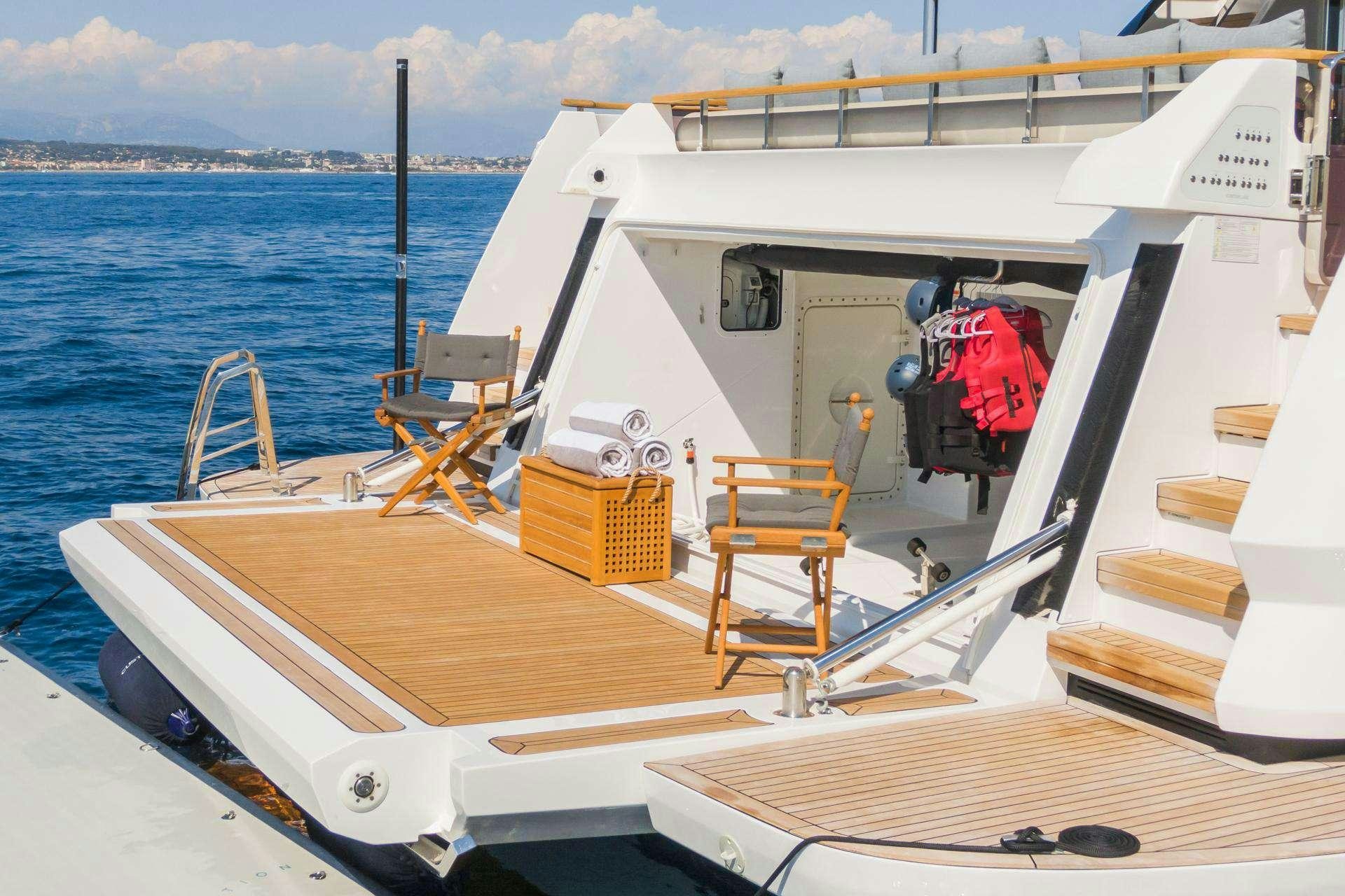 a boat with a red jacket on the deck aboard MRS L Yacht for Charter