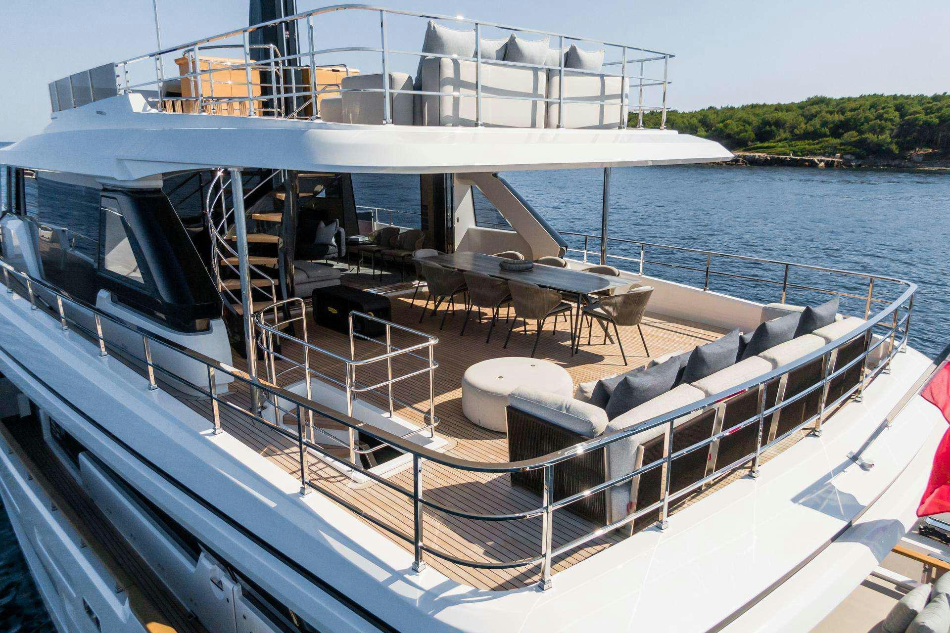a deck with a deck and chairs on it aboard MRS L Yacht for Charter