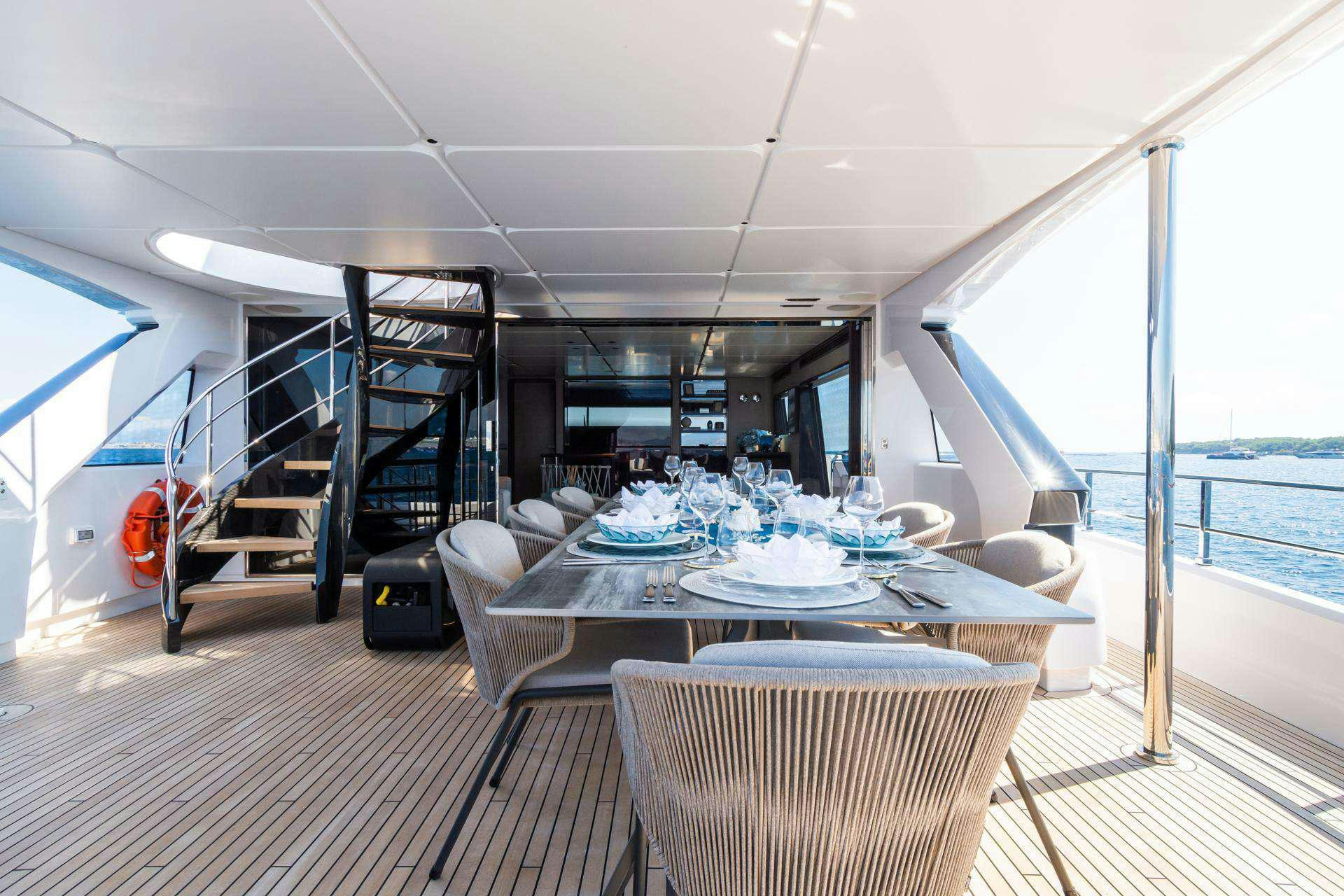 a large dining room with a large balcony aboard MRS L Yacht for Charter