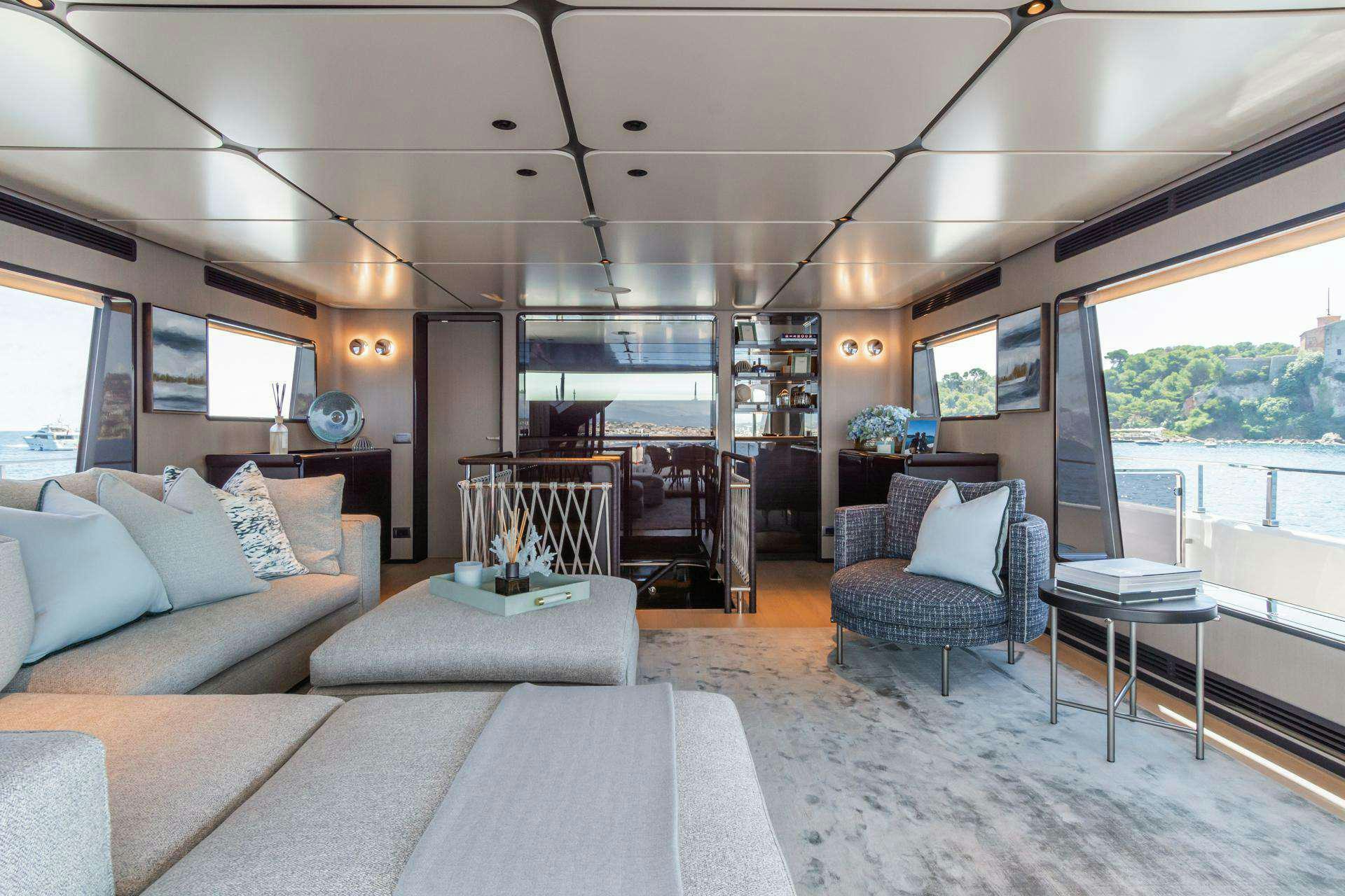 a living room with a large window aboard MRS L Yacht for Charter