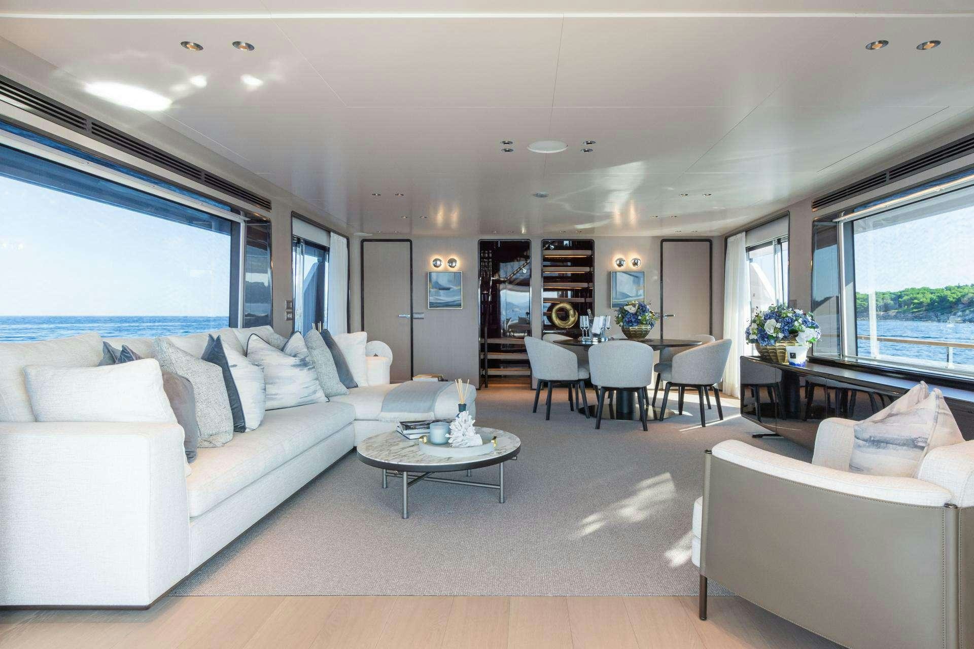 a living room with a white couch and a coffee table aboard MRS L Yacht for Charter