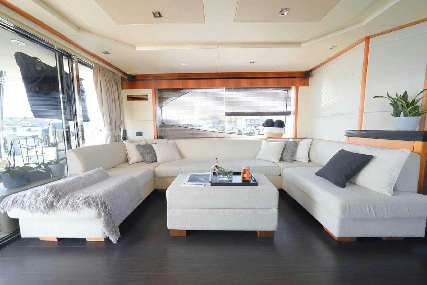 a living room with a couch and a coffee table aboard CATCH THE WAVE Yacht for Charter