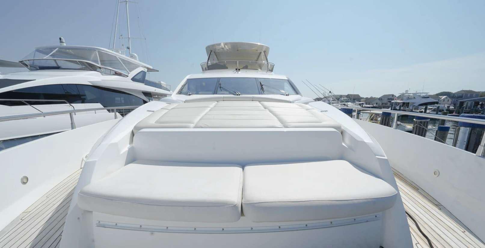 a white yacht in a harbor aboard CATCH THE WAVE Yacht for Charter
