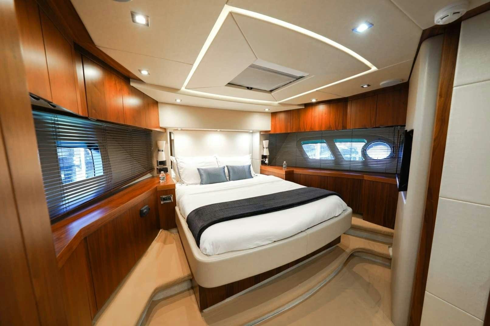 a room with a bed and a window aboard CATCH THE WAVE Yacht for Charter