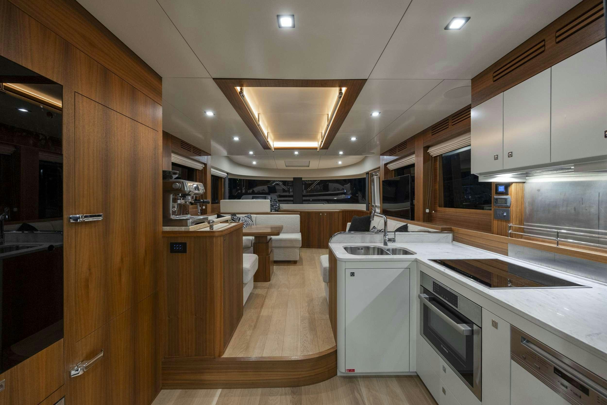 a kitchen with white cabinets aboard OBRIGADA Yacht for Charter