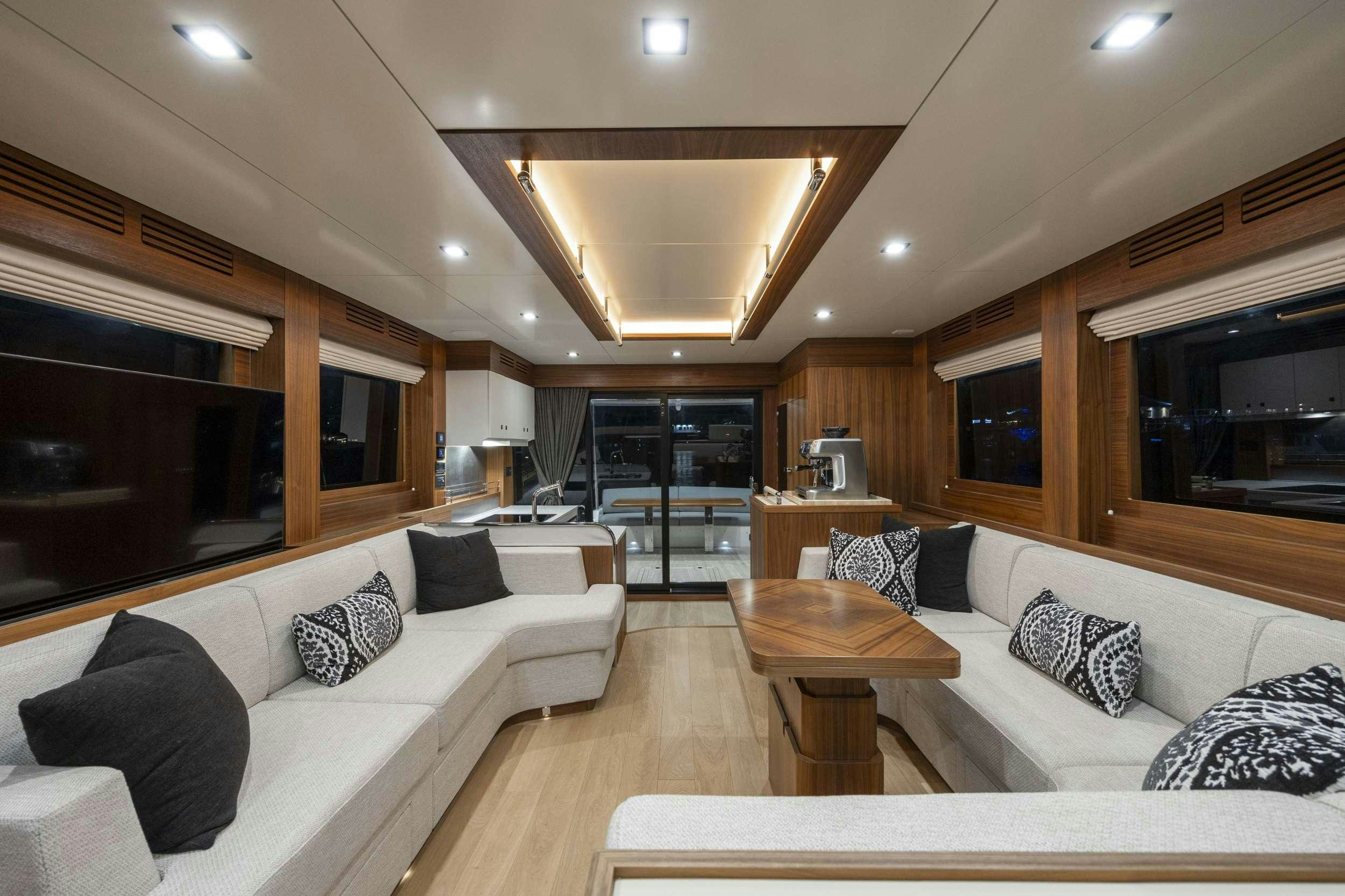 a living room with a couch and a coffee table aboard OBRIGADA Yacht for Charter