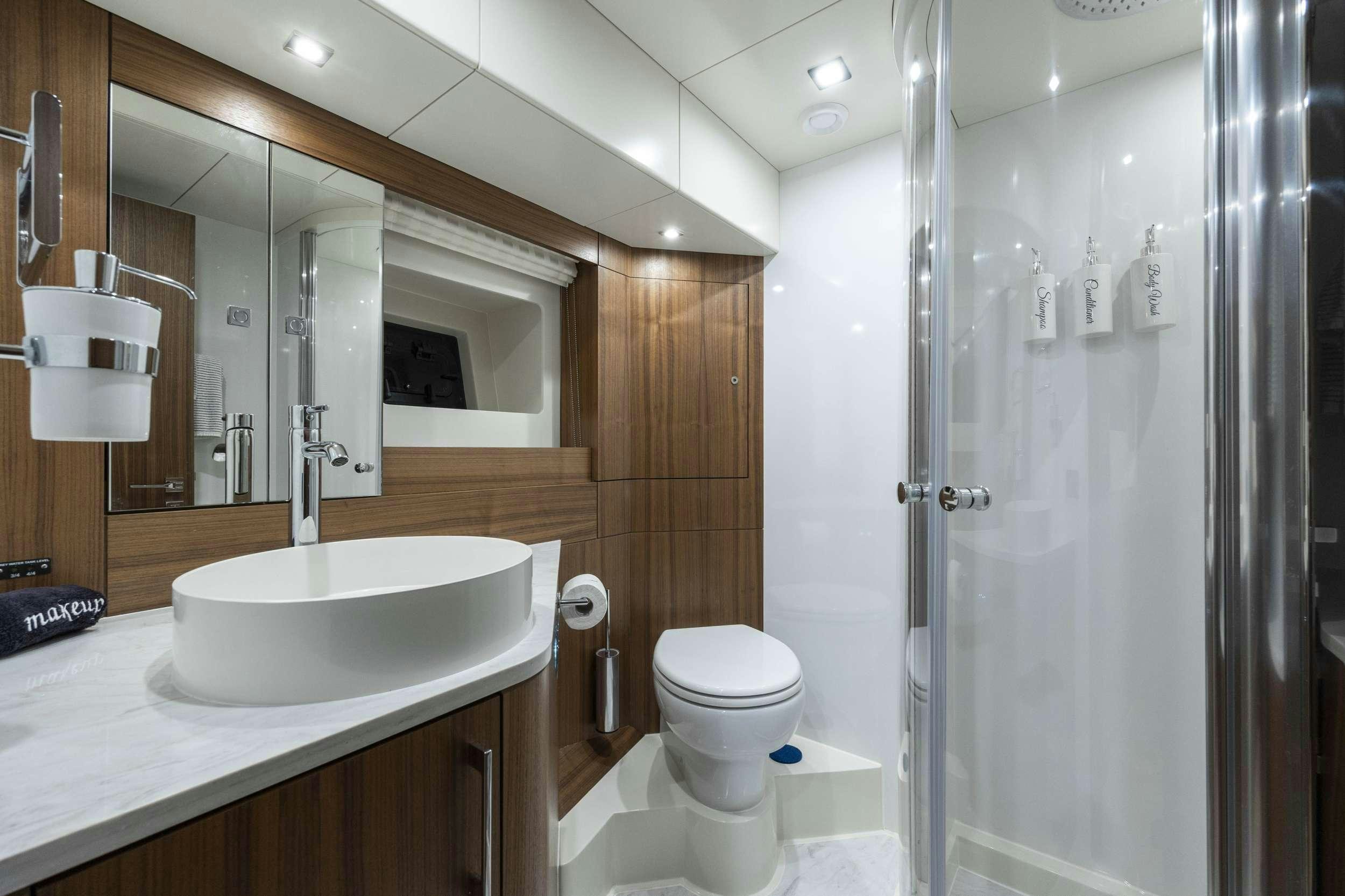 a bathroom with a sink and a toilet aboard OBRIGADA Yacht for Charter
