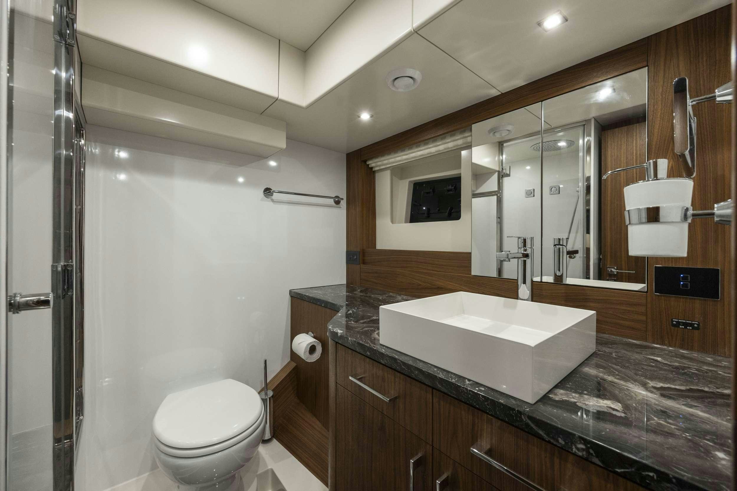 a bathroom with a sink and a toilet aboard OBRIGADA Yacht for Charter