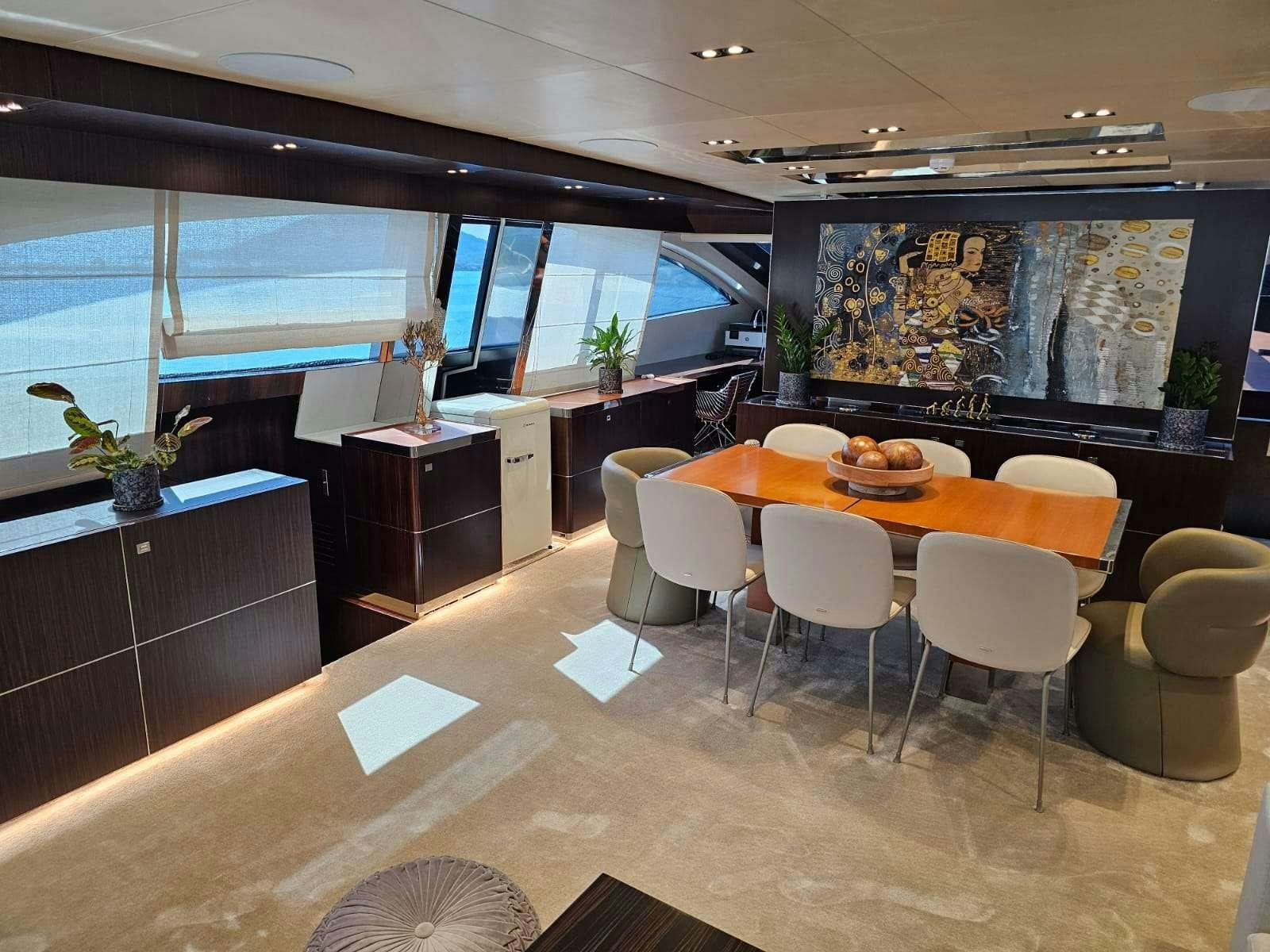 a large room with tables and chairs aboard MAC Yacht for Charter