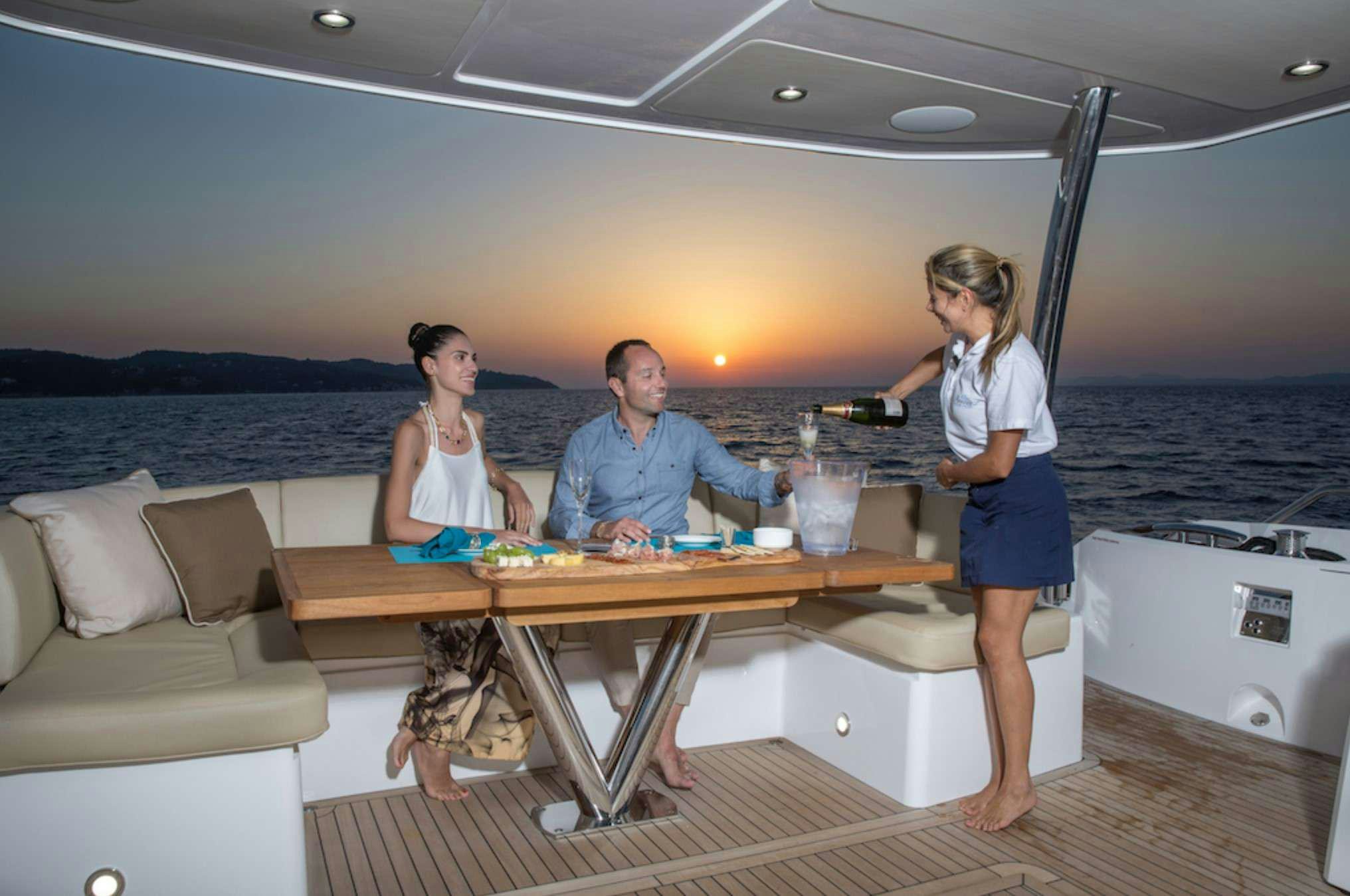 a group of people sitting at a table on a boat aboard FINEZZA Yacht for Charter