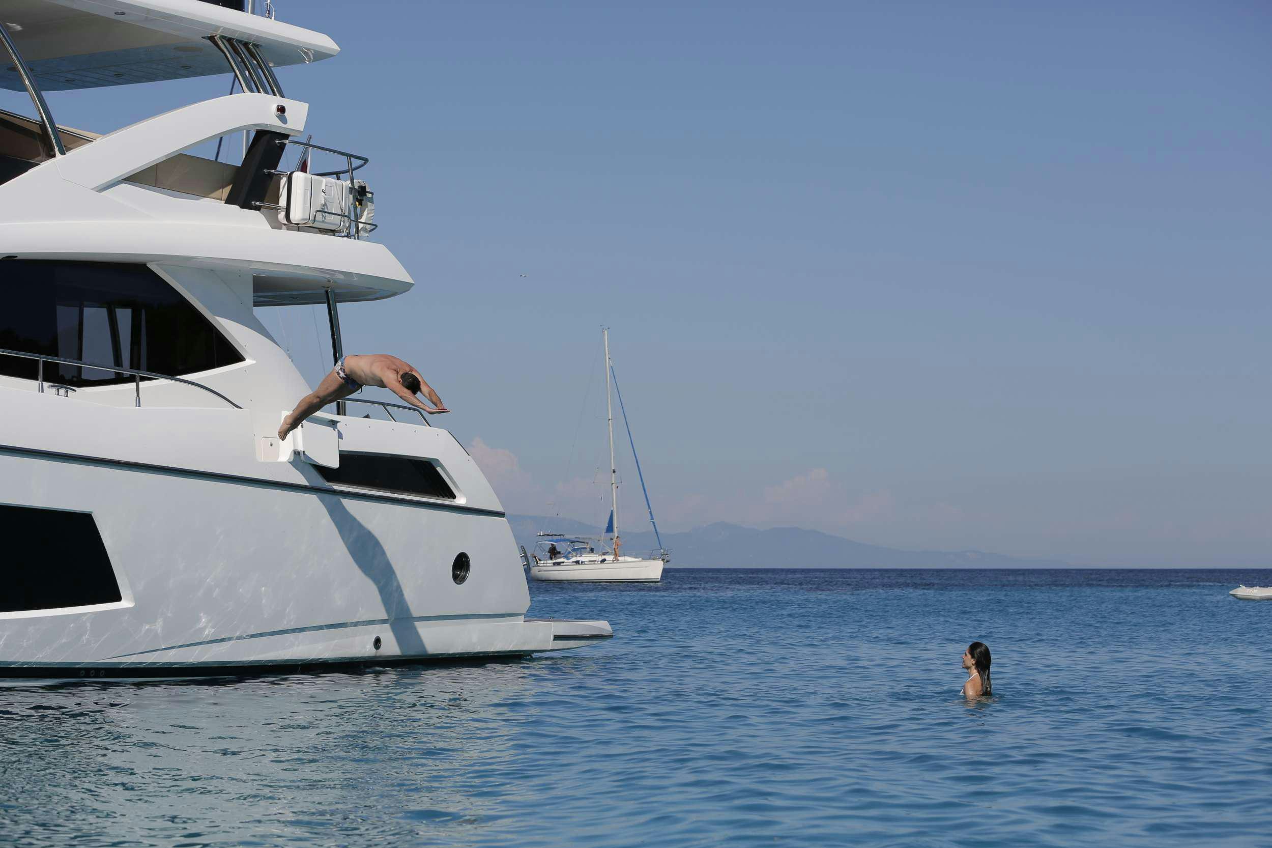 a person and a dog on a boat in the water aboard FINEZZA Yacht for Charter
