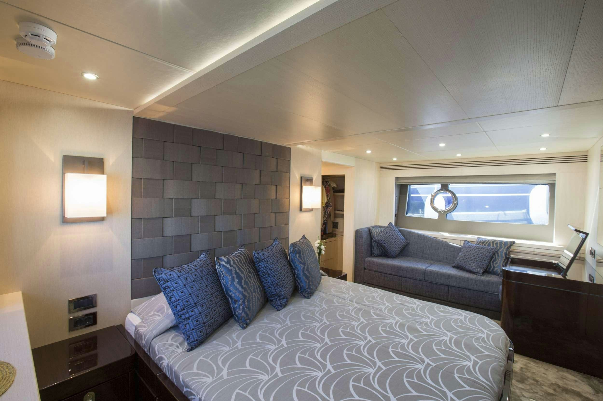 a bedroom with a bed and a couch aboard FINEZZA Yacht for Charter