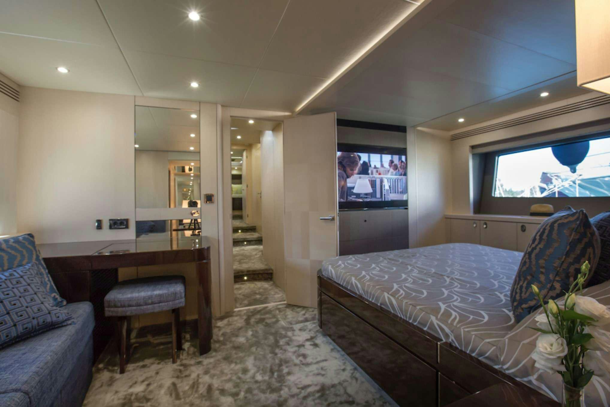 a bedroom with a bed and a desk aboard FINEZZA Yacht for Charter