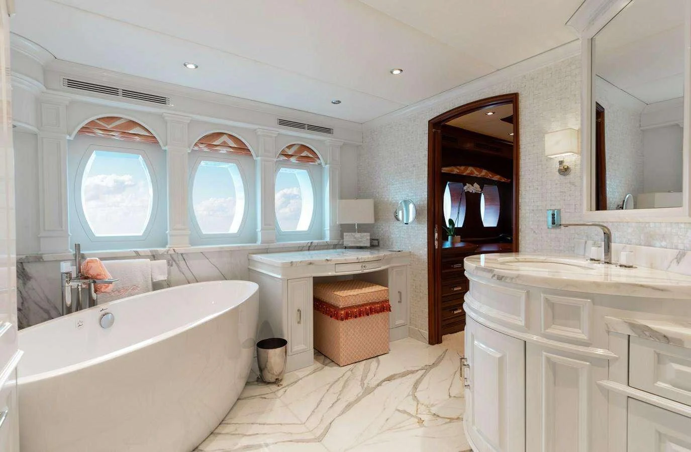 a bathroom with a tub sink and a mirror aboard BOUCHON Yacht for Charter