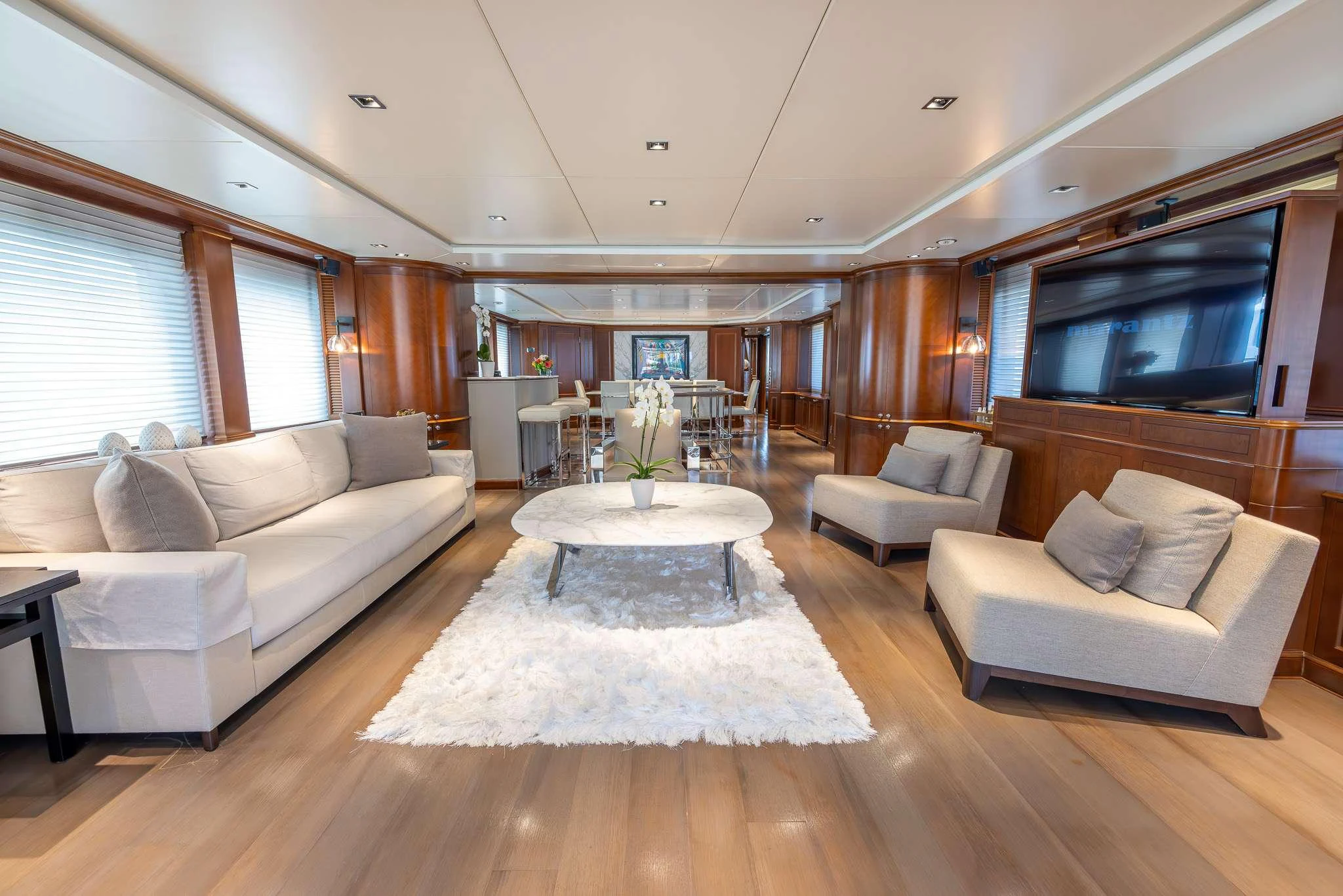 a living room with a table and couches aboard ARTHUR'S WAY Yacht for Charter