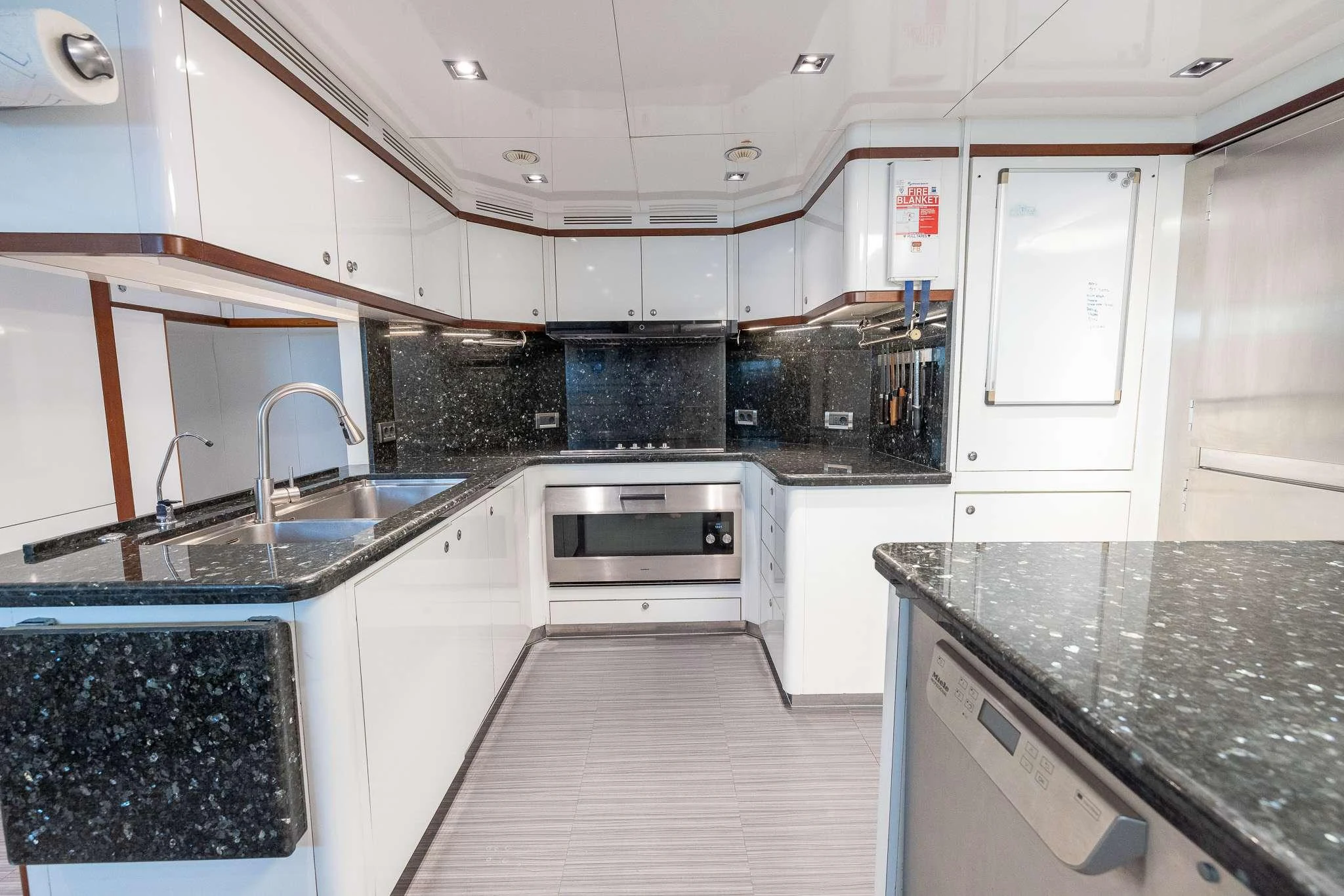 a kitchen with white cabinets aboard ARTHUR'S WAY Yacht for Charter