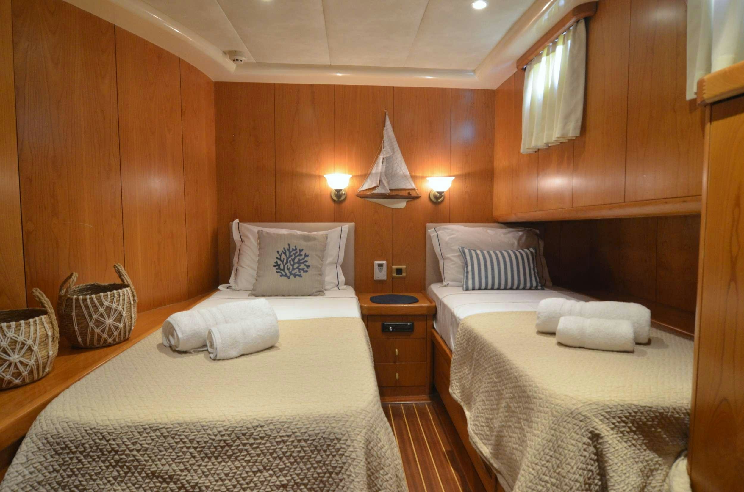 a room with two beds aboard 105 MOTOR Yacht for Charter