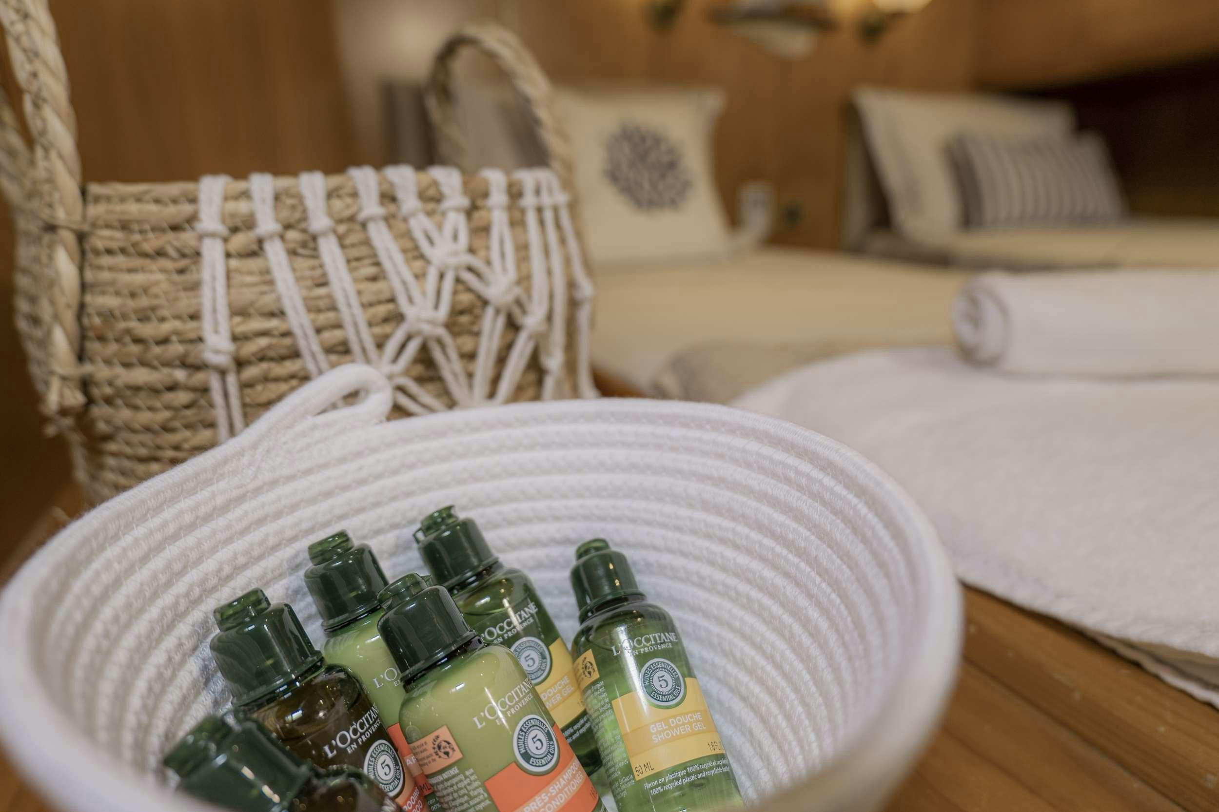 a green bottle of beer on a couch aboard 105 MOTOR Yacht for Charter