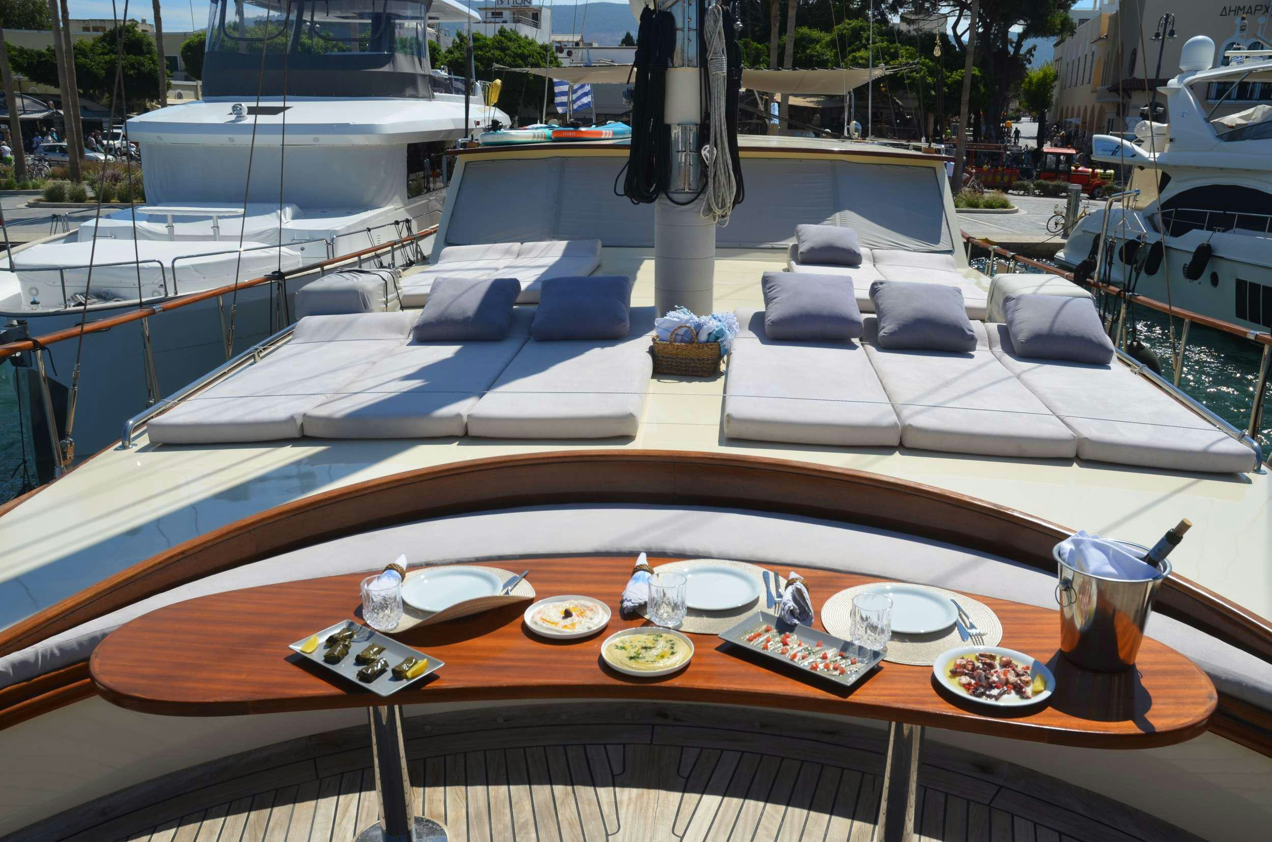 a table with plates and cups on it aboard 105 MOTOR Yacht for Charter