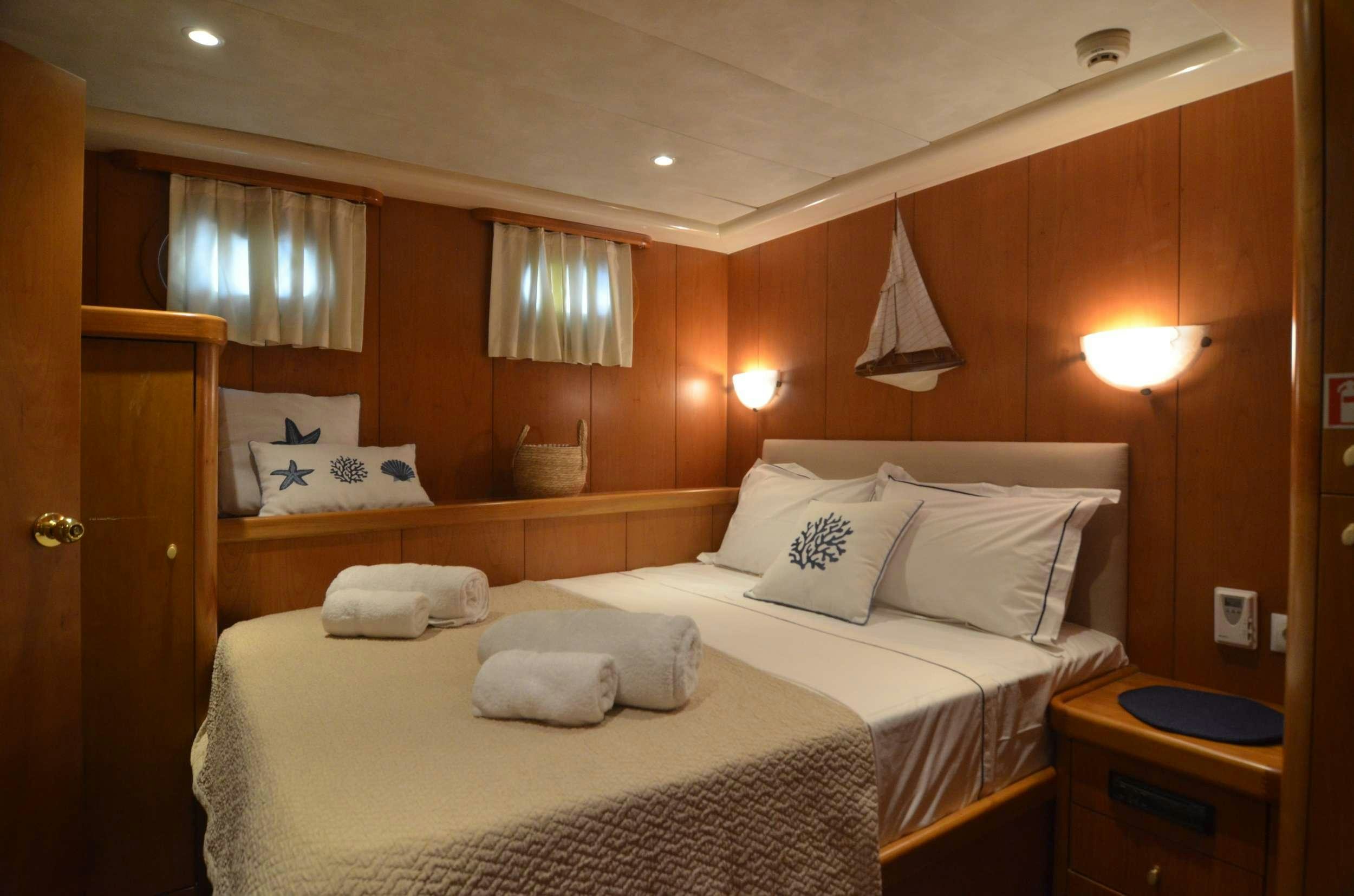 a room with two beds aboard 105 MOTOR Yacht for Charter