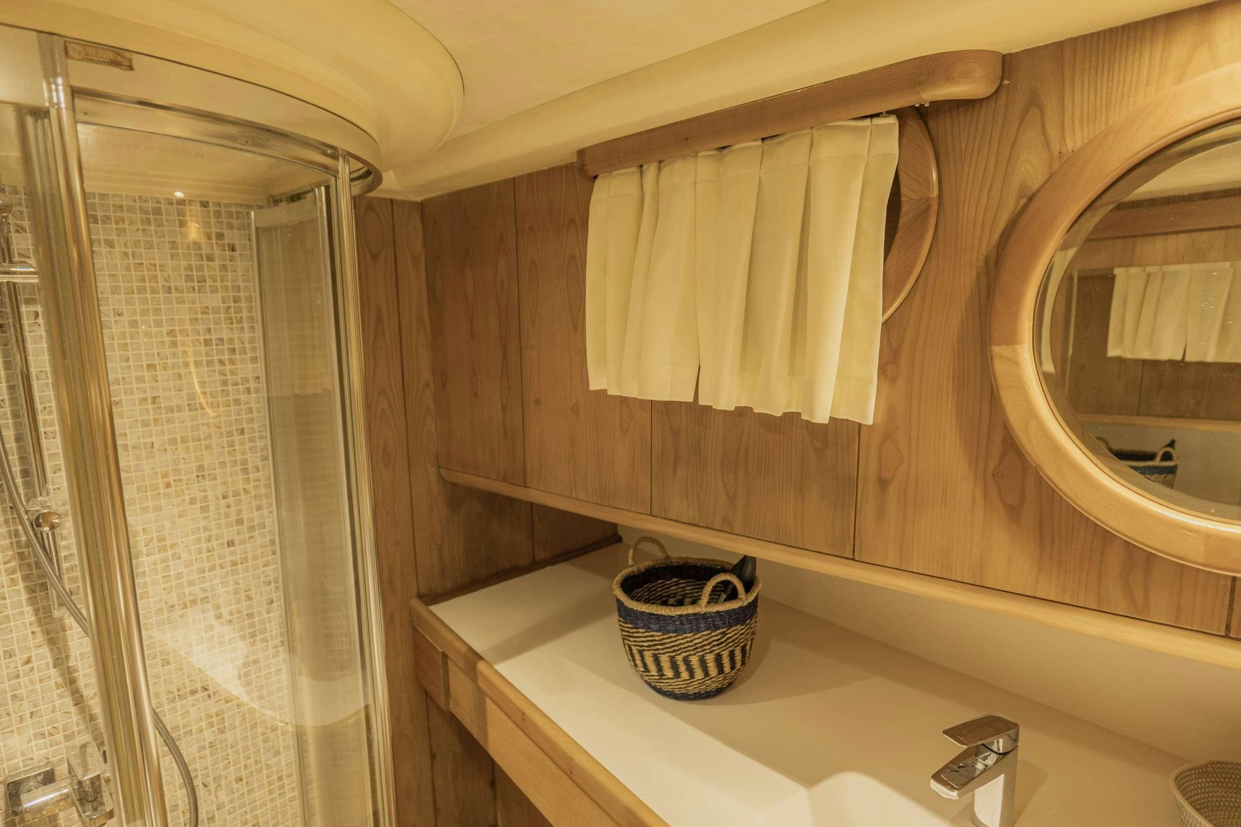 a bathroom with a tub and shower aboard 105 MOTOR Yacht for Charter