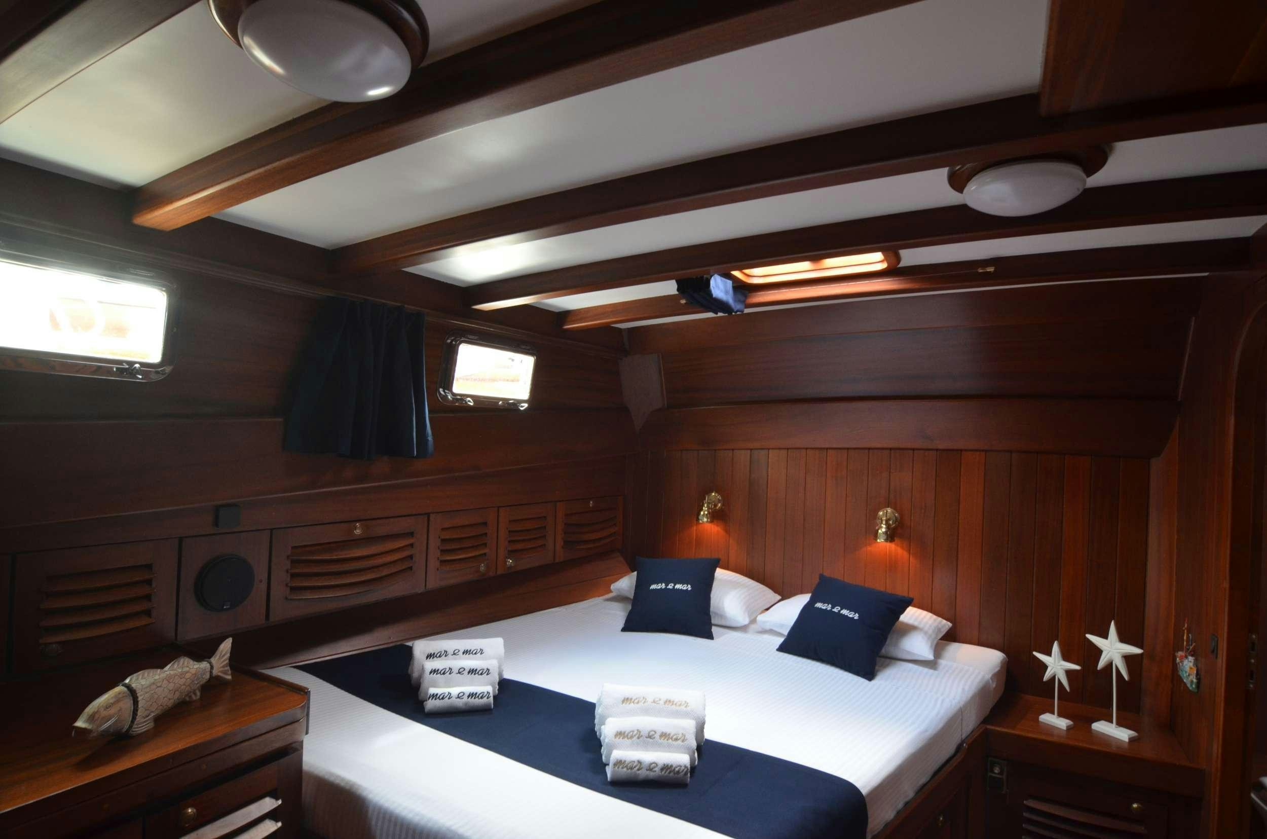 a room with a bed and a desk aboard MAR E MAR Yacht for Charter
