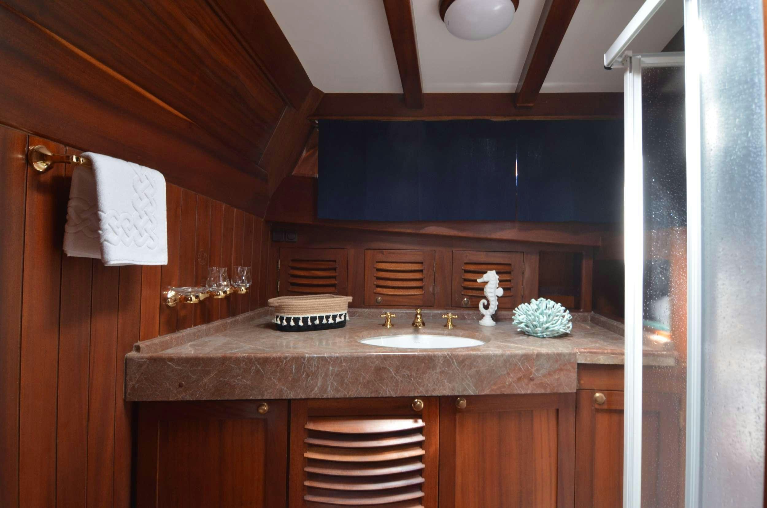 a bathroom with a sink and cabinets aboard MAR E MAR Yacht for Charter