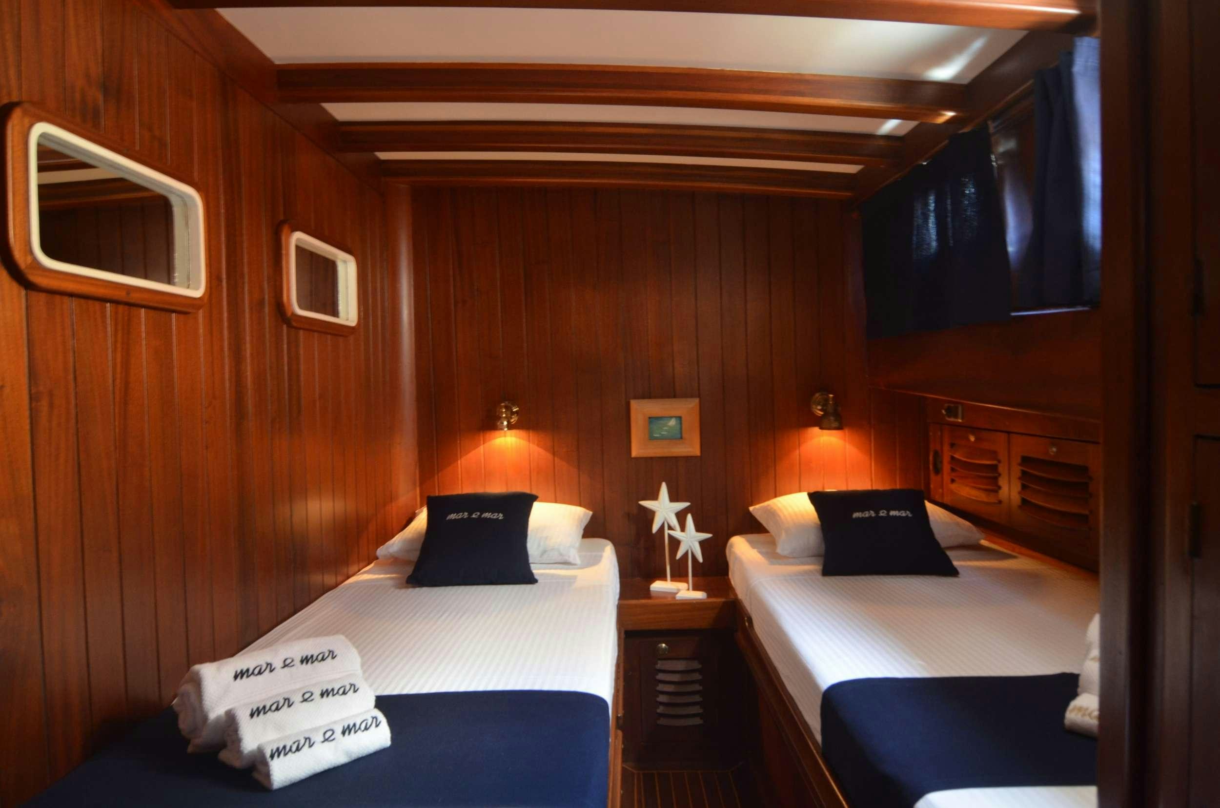 a room with two beds aboard MAR E MAR Yacht for Charter