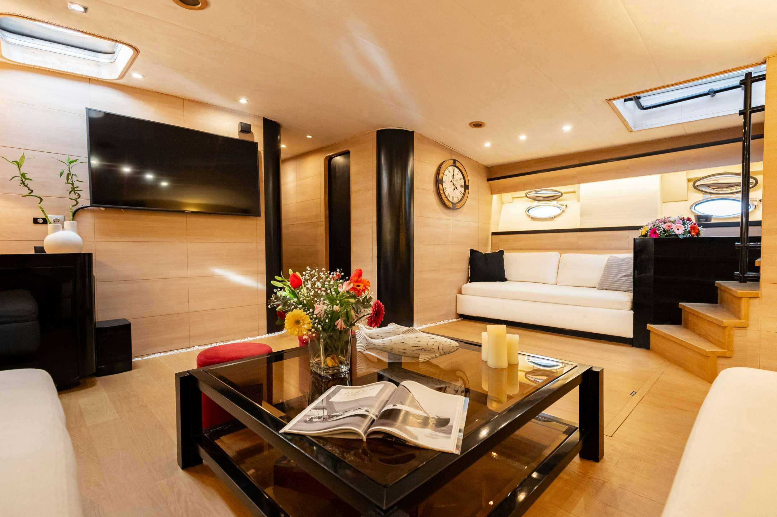 a living room with a couch and a coffee table aboard ELEGANT Yacht for Charter