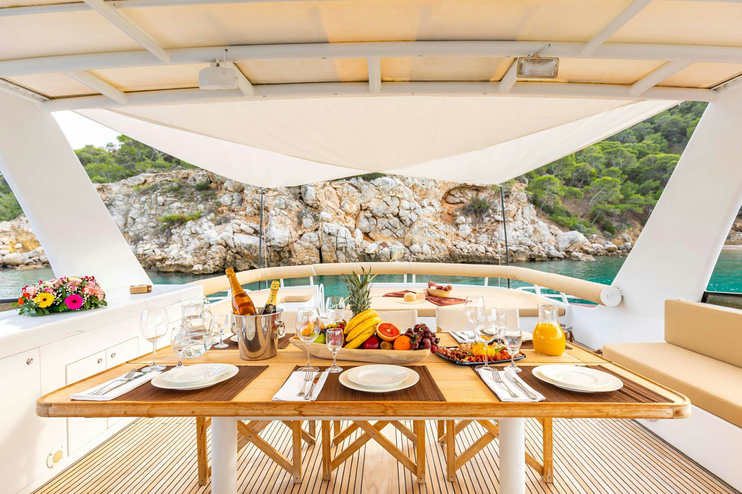 a table with plates and glasses on it aboard ELEGANT Yacht for Charter