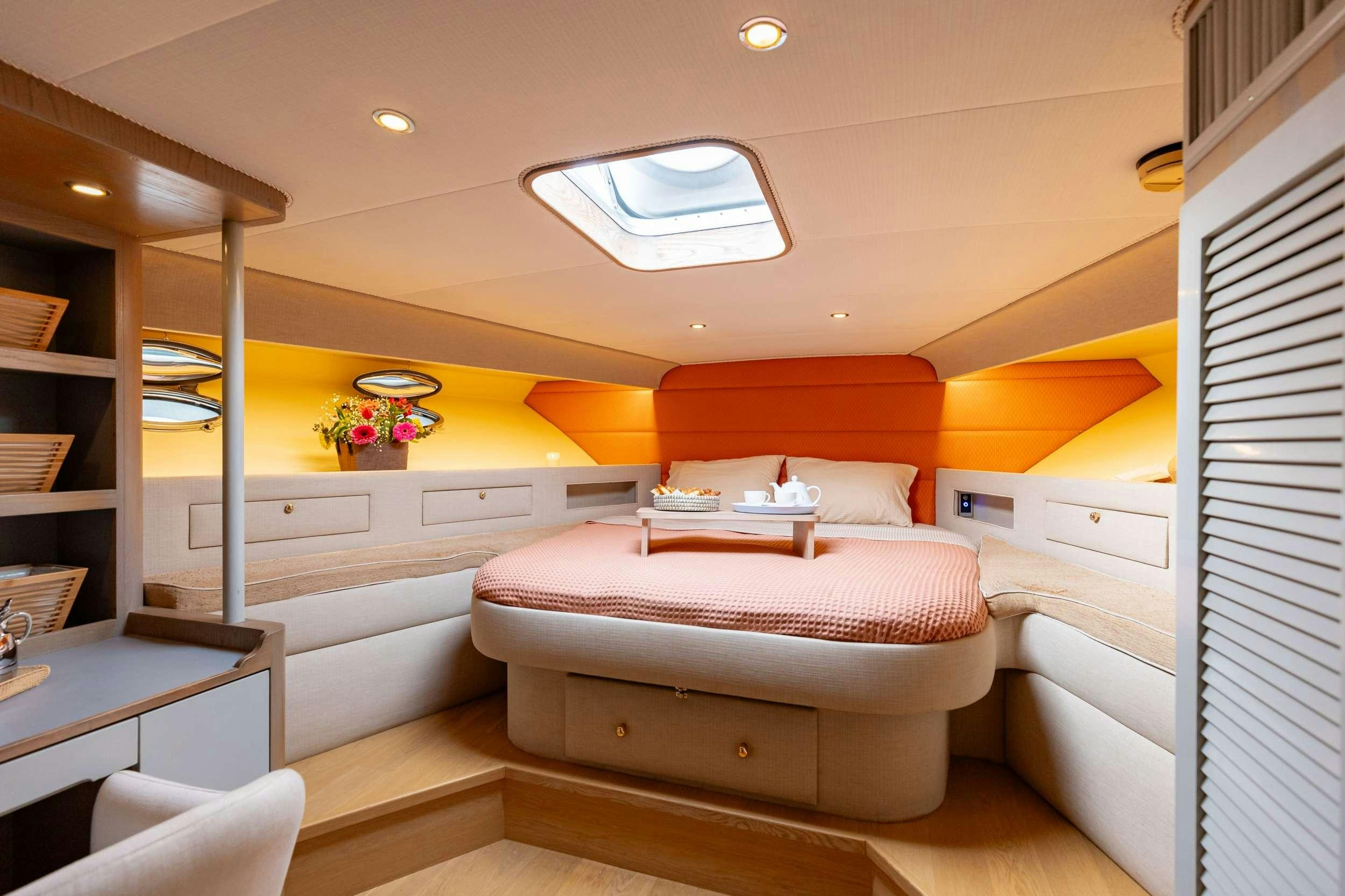 a room with a bed and a desk aboard ELEGANT Yacht for Charter
