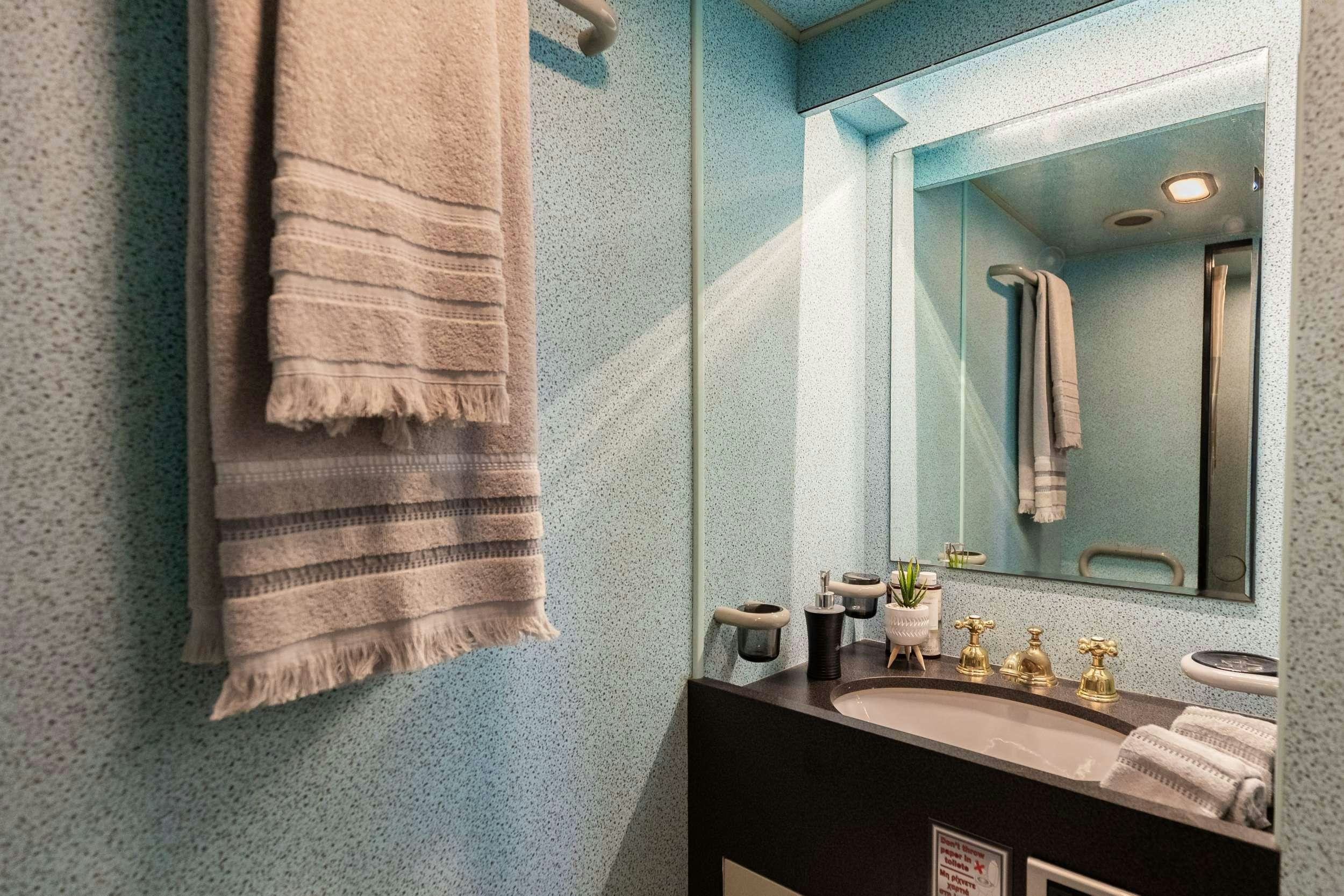 a bathroom with a towel and a mirror aboard ELEGANT Yacht for Charter