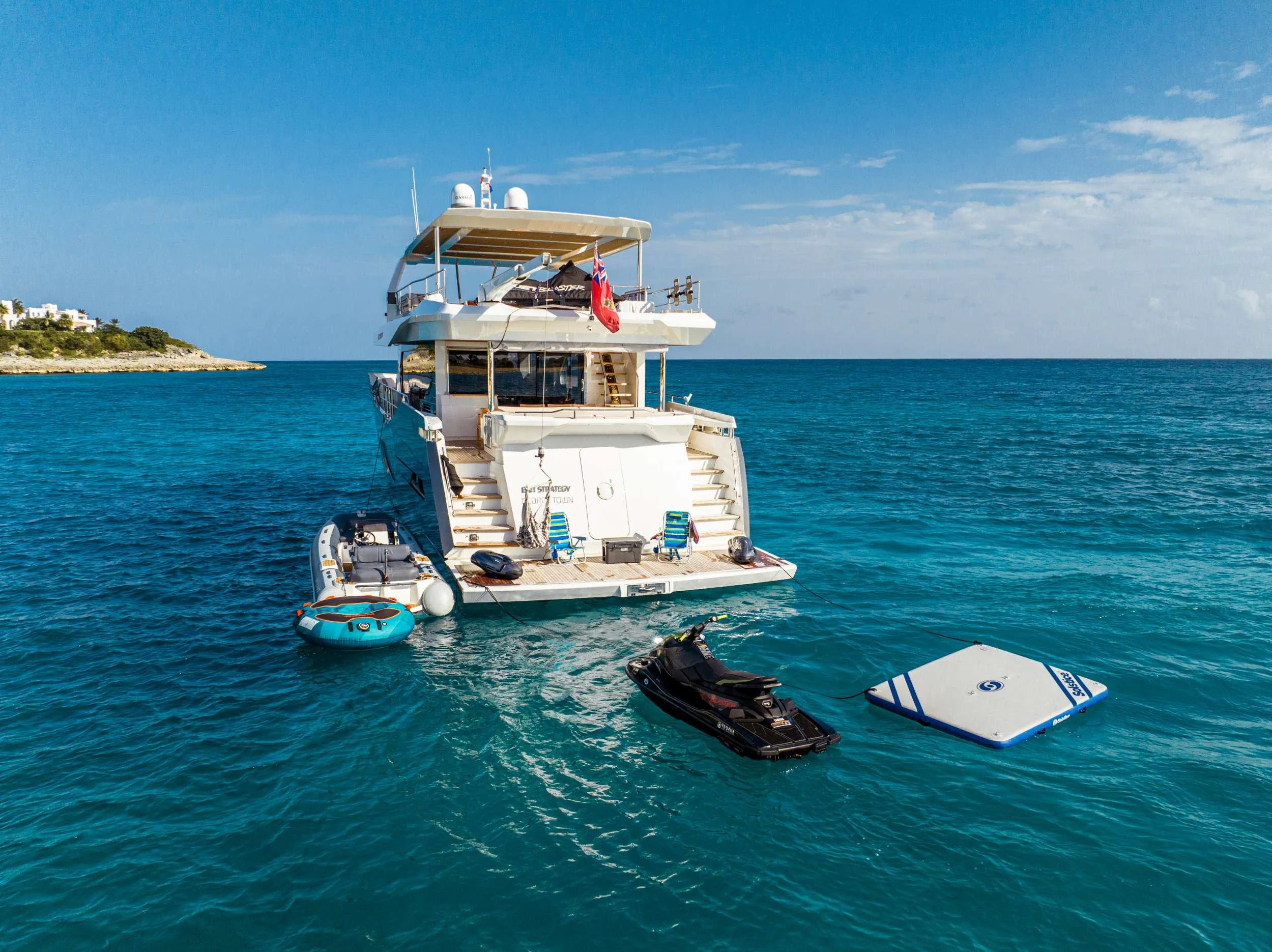 a boat and a couple of boats in the water aboard EXIT STRATEGY Yacht for Charter