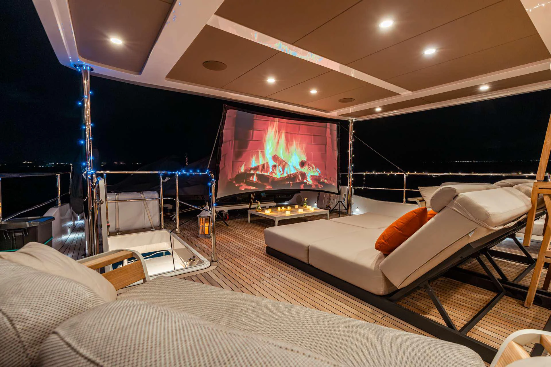a large living room with a large screen aboard EXIT STRATEGY Yacht for Charter