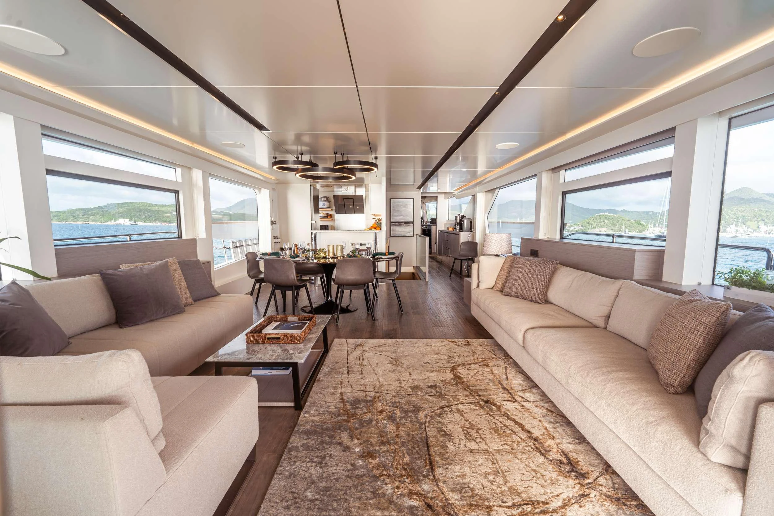 a living room with a couch and a table aboard EXIT STRATEGY Yacht for Charter