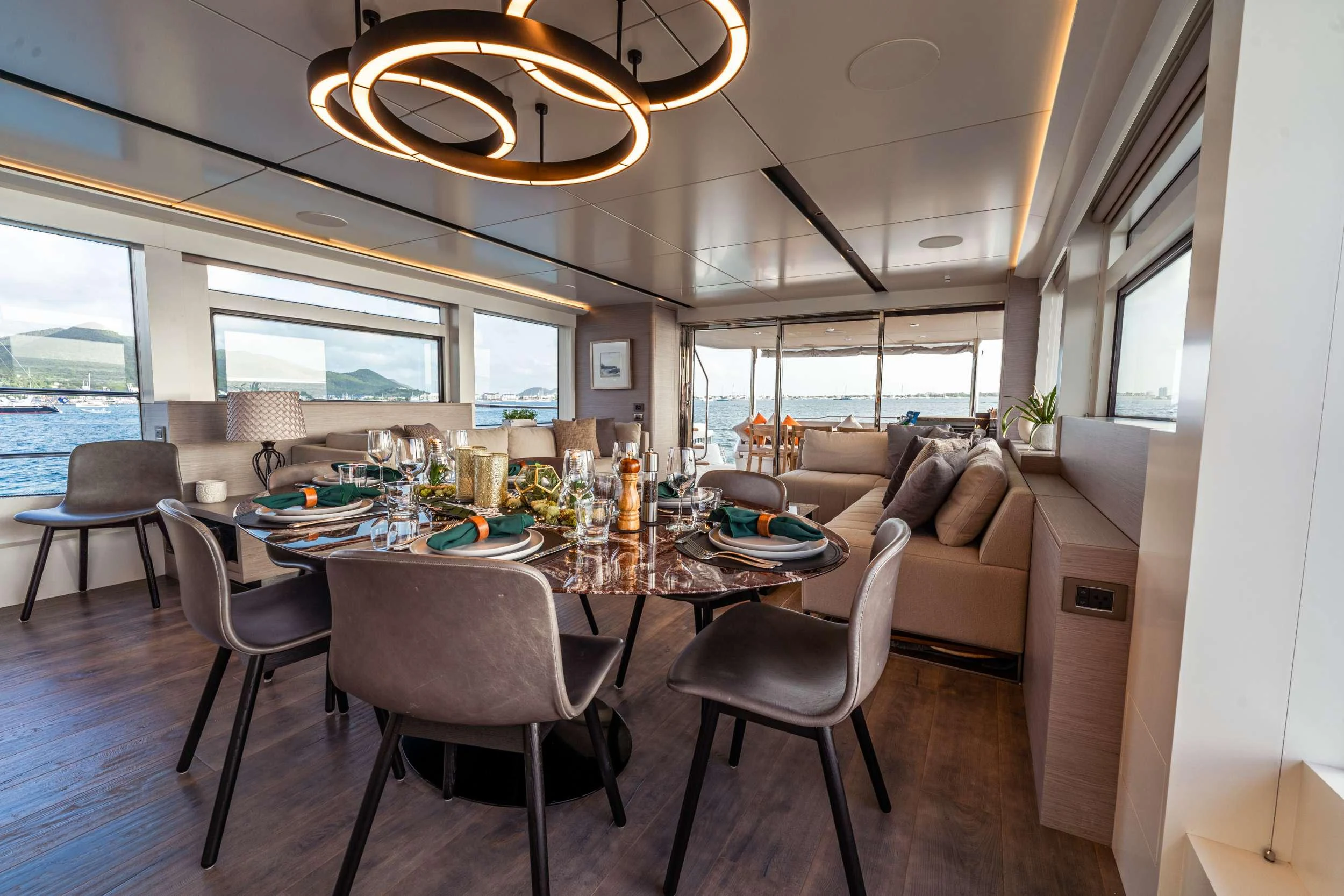 a large dining table in a living room aboard EXIT STRATEGY Yacht for Charter