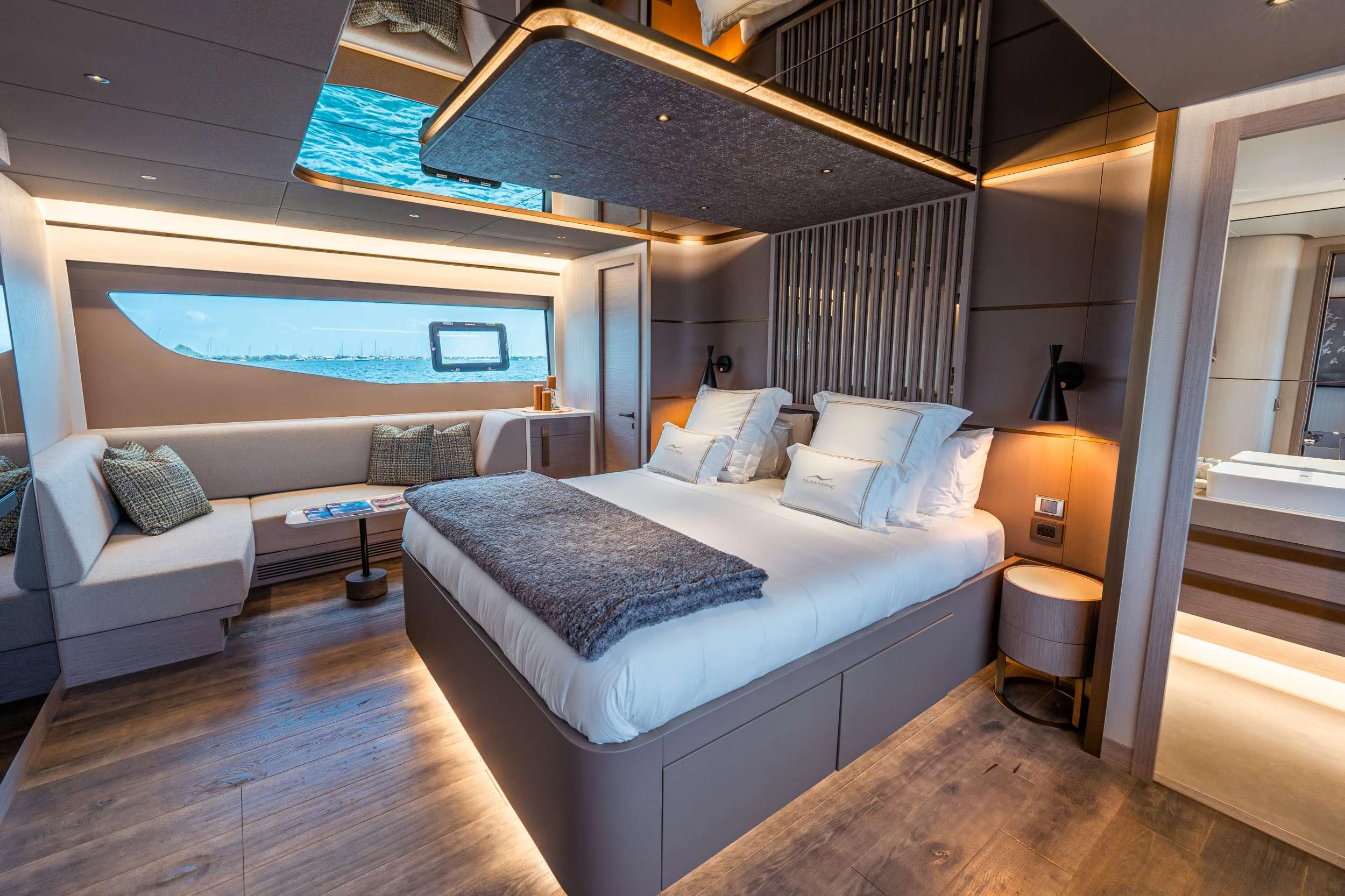 a room with a bed and a television aboard EXIT STRATEGY Yacht for Charter