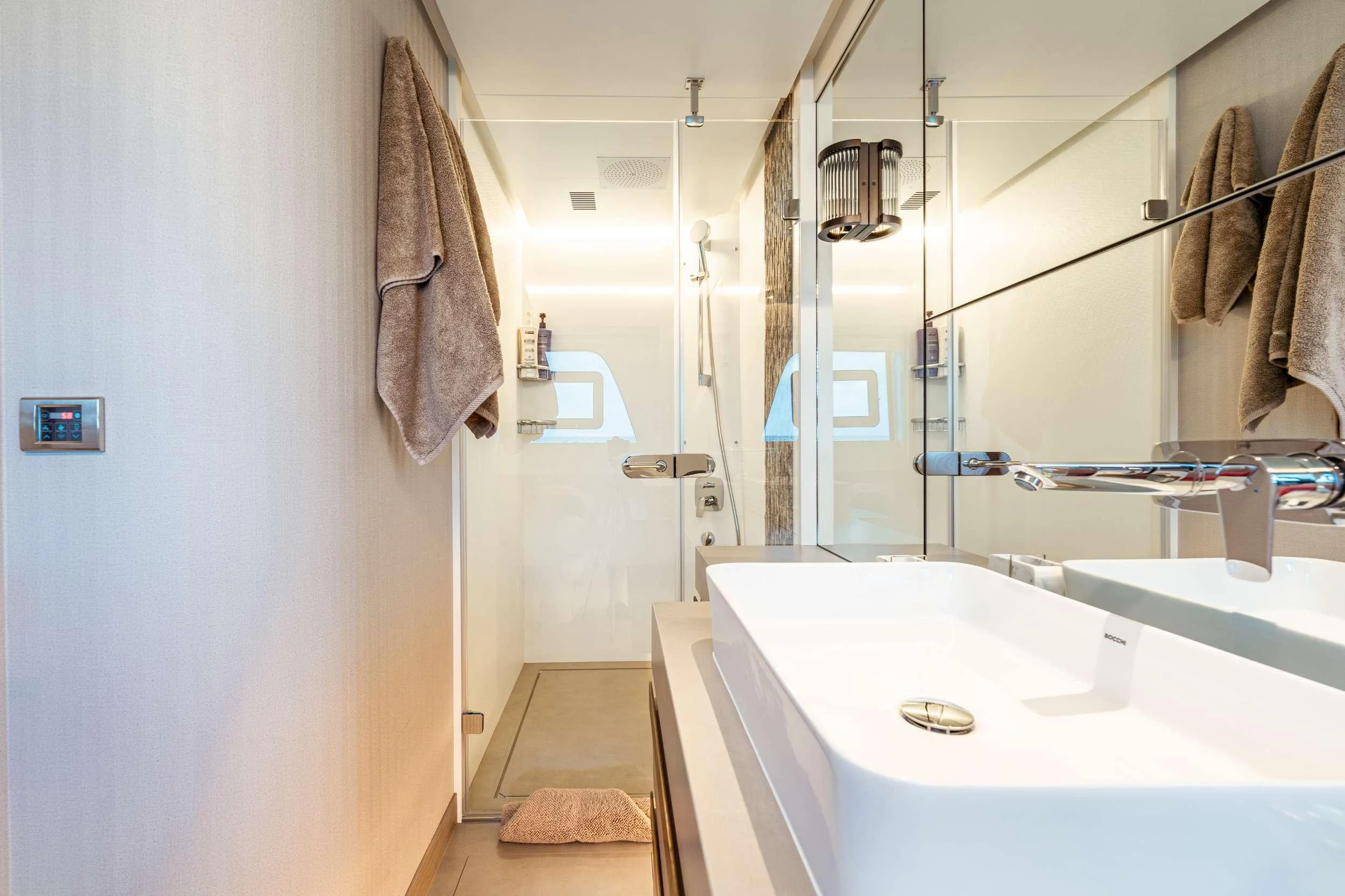 a bathroom with a sink and a shower aboard EXIT STRATEGY Yacht for Charter