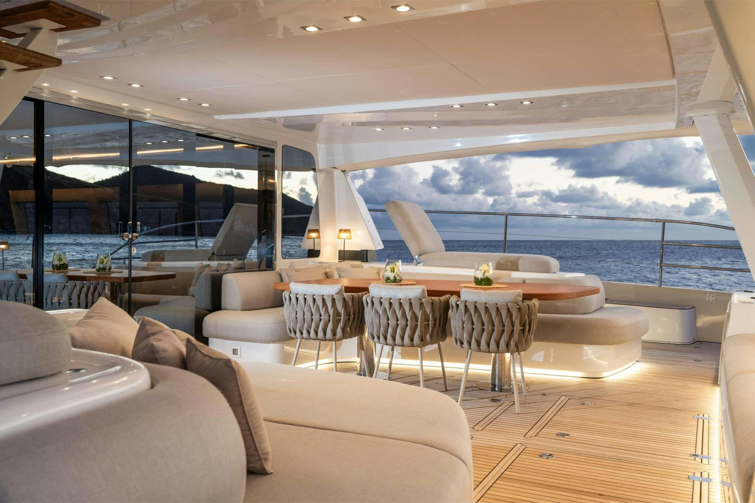 a room with a table and chairs aboard SIETE MARES Yacht for Charter