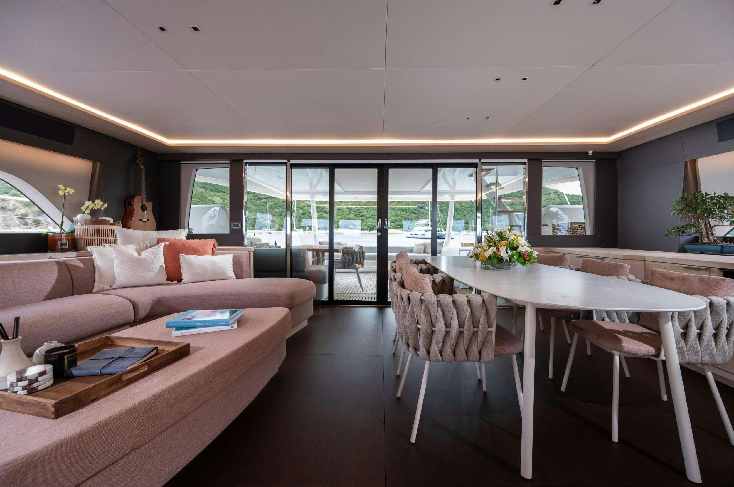 a room with a table and chairs aboard SIETE MARES Yacht for Charter