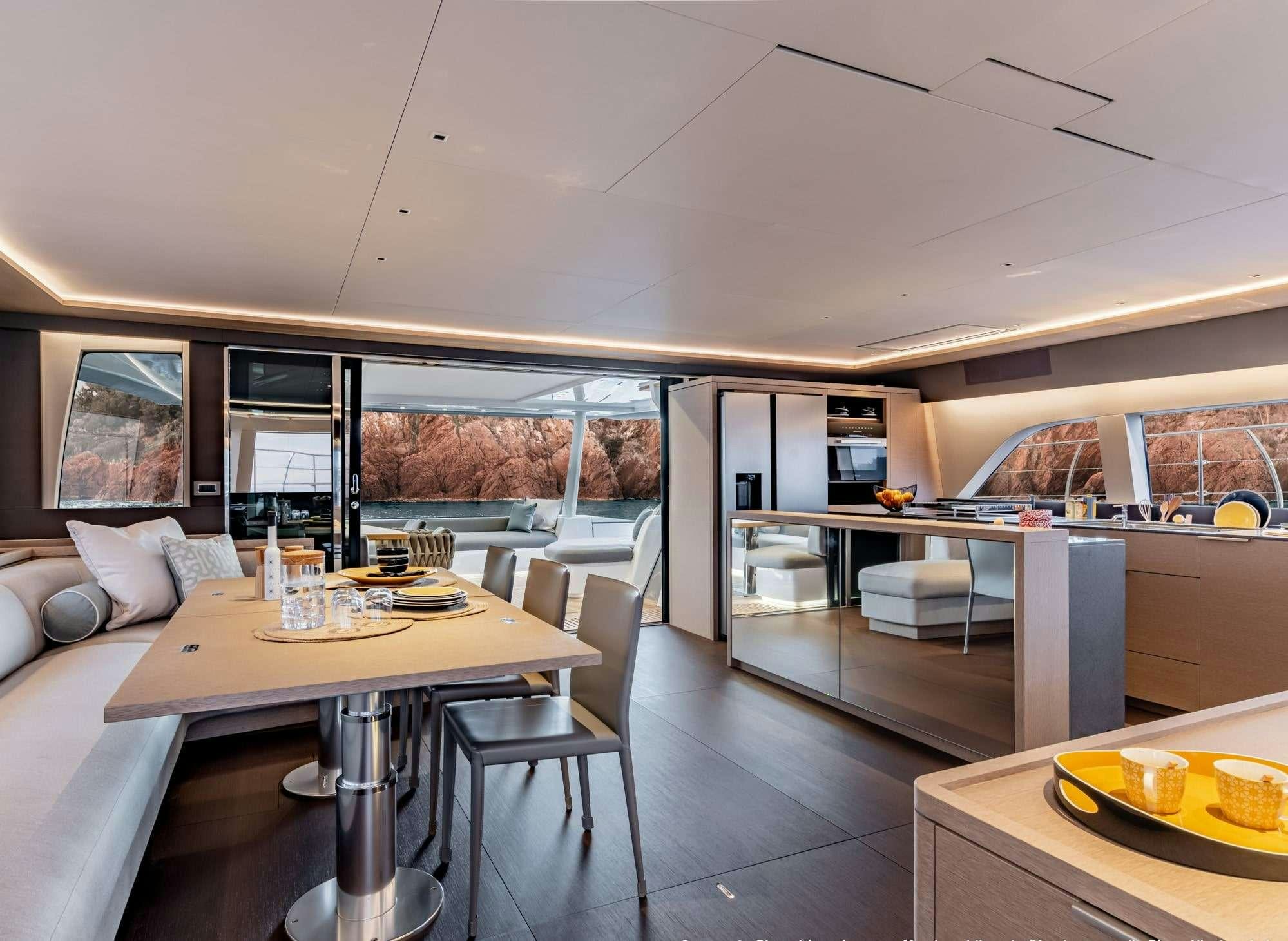 a modern looking kitchen with a large open area with a large window aboard SIETE MARES Yacht for Charter