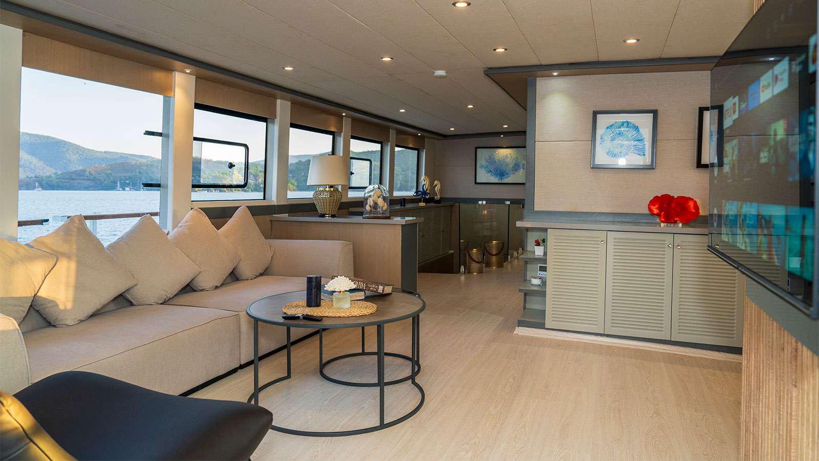 a living room with a large window aboard ALBATROS K Yacht for Charter