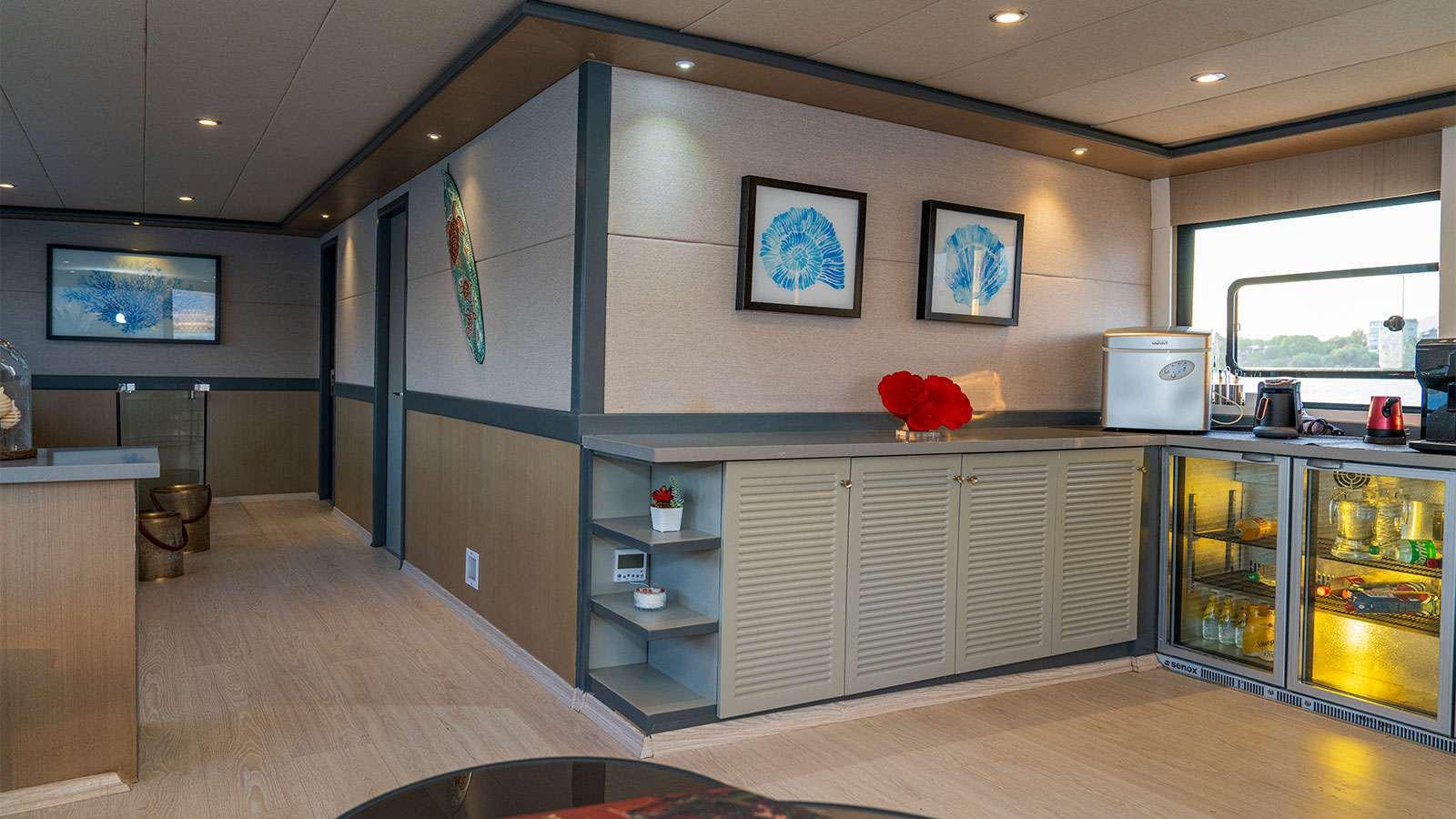 a kitchen with a glass display case aboard ALBATROS K Yacht for Charter