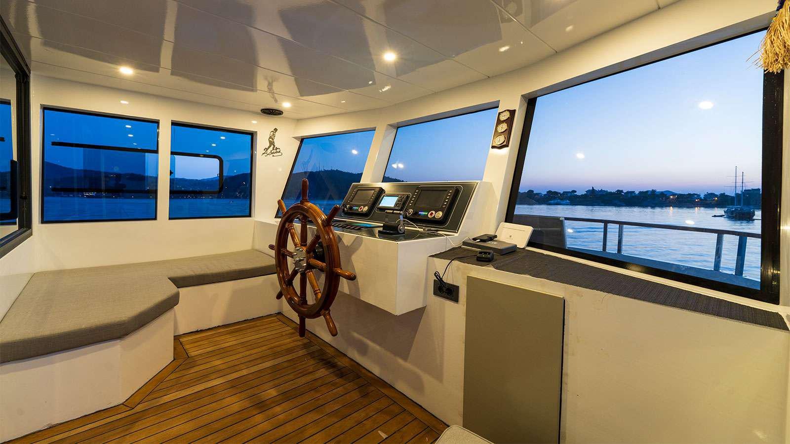 a room with a large window and a large wood floor with a large window and a view of aboard ALBATROS K Yacht for Charter