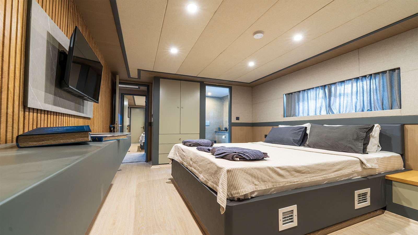 a bedroom with a large bed aboard ALBATROS K Yacht for Charter